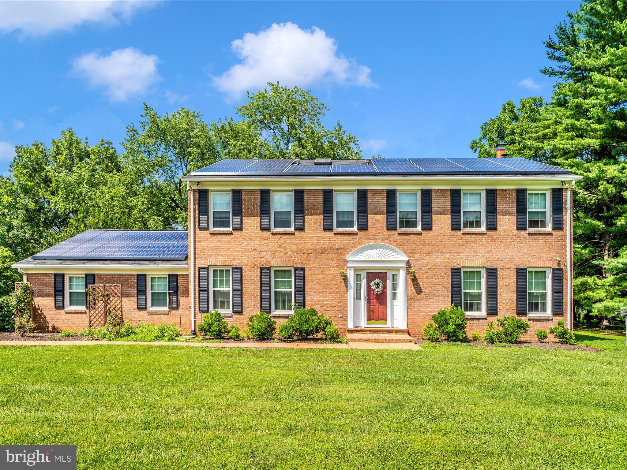 Welcome to this beautiful and highly desirable brick colonial home on a corner lot of 1.44 acres, offering over 3,500 sq ft of living space, 4 bedrooms, and 3.5 bathrooms. Drive up the repaved driveway to an updated stone walkway, and step into a welcoming tile entryway with gleaming updated floors in the kitchen and breakfast nook, complemented by well-kept hardwood throughout the main level. The layout includes formal living and dining rooms, ideal for entertaining. The updated kitchen features quartz countertops, stainless steel appliances, and a stylish range hood, with a sun-filled breakfast area that opens to a stone patio, perfect for relaxing or hosting guests.
The serene and private backyard provides a peaceful retreat, while the cozy family room boasts a brick-front fireplace. Also on the main level are a laundry room and a half bathroom for added convenience. Upstairs, the spacious owner’s suite includes a cedar-lined walk-in closet, ceiling fan, and double vanity, along with a soaking tub and private shower for a spa-like experience. Three additional bedrooms and a full hall bath with tub/shower complete the upper level. The fully finished lower level offers even more living space with stunning bamboo flooring, a large family room with a wood burning stove, a versatile flex room with access to the garage, and a generous storage area. The attached garage includes ceiling-mounted storage and a 220V power supply, which can be converted for EV charging. The home also features a central vacuum system and is located near parks and walking trails for added outdoor enjoyment.
Recent upgrades include: Front walkway & back patio stonework, whole house windows and front shutters, range hood, repaved driveway, water softener and pH neutralizer, well pump, washer/dryer, dishwasher, electric range, reverse osmosis system (kitchen), main and lower-level flooring, and full interior repaint including the garage. This is an option for some borrowers — the mortgage is assumable at 3.25% (FHA loan), a rare opportunity not to be missed! However, if a buyer does not wish to assume the loan, they can still purchase the home.