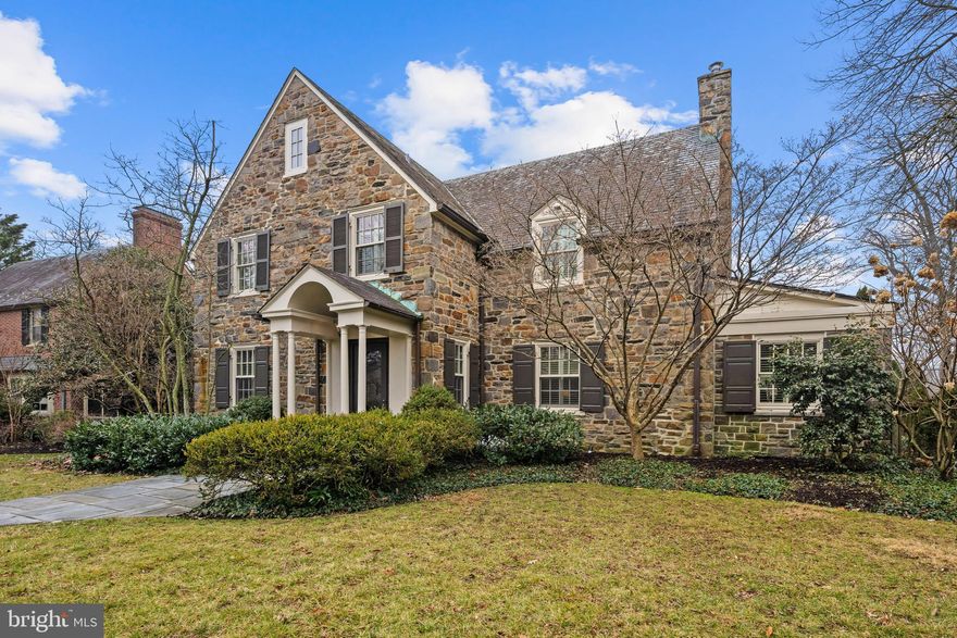 Stylish and sophisticated and completely updated stone Colonial home in the heart of Homeland offering five bedrooms, three full and three half baths, and an attached garage.  A welcoming foyer greets you upon entry, featuring beautifully crafted built in storage, providing both charm and practical organization. To the left, the professionally designed chef’s kitchen serves as a central gathering space, showcasing high end, restaurant quality appliances including a professional six burner stainless gas range with double ovens, custom cabinetry, stone countertops, and an expansive island that anchors the room and opens to the dining room, ideal for both everyday living and effortless entertaining. To the right, the gracious living room with wood burning fireplace flows seamlessly into a cozy den highlighted by striking stone walls, creating a warm and inviting retreat. The upper levels host five generously sized bedrooms complemented by three and a half  beautifully appointed  baths. The finished lower level provides exceptional flexible living space with a spacious recreation room featuring a kitchenette, convenient laundry area, abundant storage, and a half bath. Outdoors, the private fenced rear yard offers a flagstone patio and is a wonderful setting for outdoor dining and relaxed gatherings.