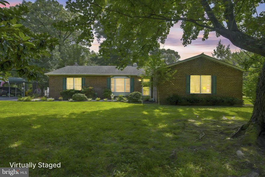 This spacious and well-maintained home offers the ease of one-level living at it's best. The modern kitchen opens to a cozy family room with sliding door leading to a stunning sunroom and adjacent deck—perfect for relaxing or entertaining. Enjoy formal spaces with both a living room and dining room, along with a generous primary suite complete with a private full bath. Two additional bedrooms and a second full bath provide plenty of space for family or guests. Additional highlights include a two-car garage, a two-car carport, a large storage shed, and a handicap-accessible ramp. Situated on a level, usable one-acre lot, this home combines comfort, functionality, and outdoor space in a peaceful setting. No covenants or restrictions.