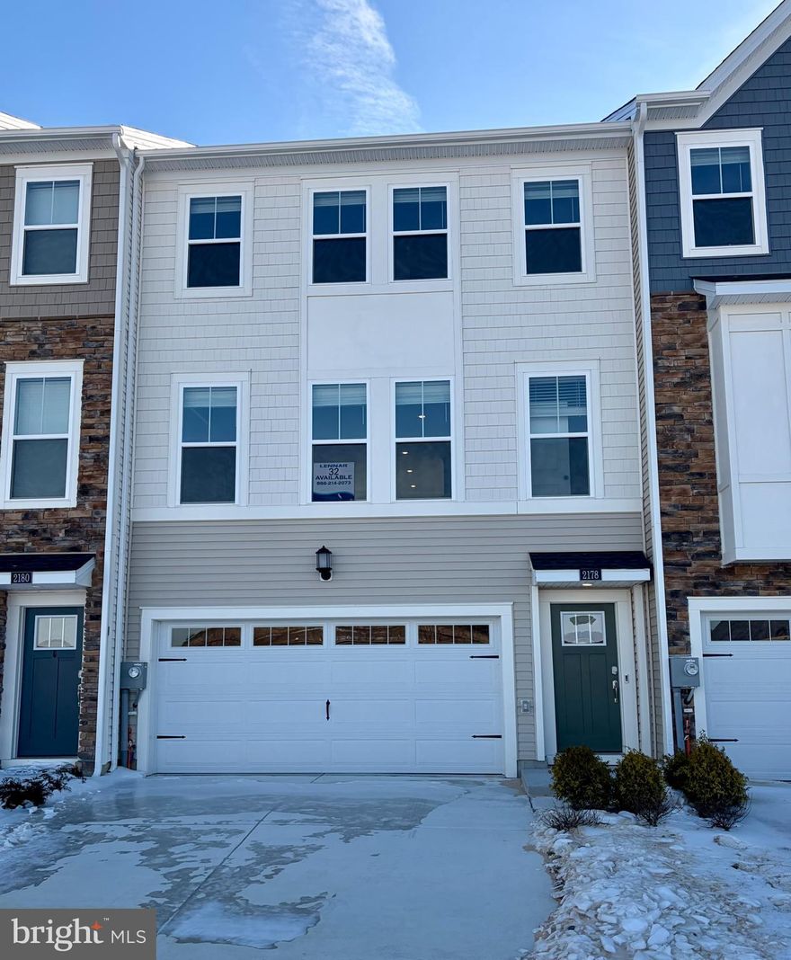 Quick Move-In opportunity! This new three-story townhome features a versatile recreation room, a large rear deck and scenic golf course views. The first level includes the recreation room and an attached two-car garage for added convenience. On the second floor, a modern open-concept layout seamlessly connects the Great Room, dining area and kitchen, along with a flex space ideal for working from home. All three bedrooms are privately situated on the top floor, including the owner’s suite with a well-appointed private bath, offering a peaceful retreat.