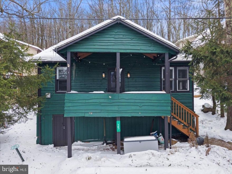 In Lake Harmony, properties that offer both lifestyle and income are rare. 35 S Lake Drive delivers both - a turnkey short-term rental generating over $40K annually while serving as a true four-season Pocono retreat. Located in the heart of Lake Harmony with access to boating, beaches, dining, and skiing at Big Boulder, this property places you minutes from year-round recreation. Whether summer days on the lake or winter weekends on the slopes, this is a destination buyers return to. Currently operating as an active STR, the home has produced documented revenue exceeding $40K annually despite limited owner usage. Active reservations can be honored and transferred, allowing the next owner to step into immediate income potential. Inside, the open layout is designed for gathering, with large windows bringing in natural light and wooded views. The kitchen flows seamlessly into the living and dining areas, creating an inviting space for guests. Two bedrooms and an updated full bath provide flexible accommodations. Outdoor living enhances the experience with a covered deck, porch, and fire pit area - ideal for entertaining after a day on the lake or slopes. Off-street parking adds convenience for owners and guests alike. Offered turn-key with off-street parking and outdoor space for relaxing after a day of adventure, this is a rare opportunity to own a Lake Harmony asset that performs as both a retreat and investment.