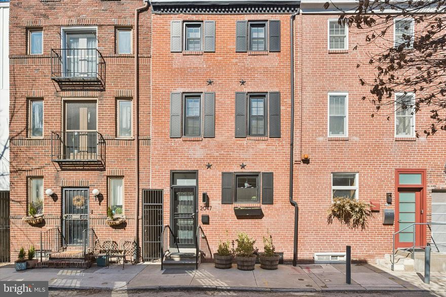 Incredible opportunity to own a beautifully reimagined home on one of the most charming blocks in Rittenhouse Square. Thoughtfully renovated from top to bottom, 2047 Waverly Street seamlessly blends modern design, refined architectural details, and preserved original character to create a truly exceptional residence. This stunning home offers 3 bedrooms, 2 full bathrooms, a lower-level den, and a private outdoor patio—an ideal combination of style, comfort, and functionality. The classic red brick façade with black trim creates striking curb appeal and sets the tone for what awaits inside. The main level welcomes you with tall ceilings, abundant natural light, and a bright, airy layout. A sleek monochrome kitchen serves as the centerpiece of the home, featuring 42-inch gray cabinetry, quartz countertops, a designer tile backsplash, herringbone tile flooring, and high-end Bertazzoni stainless steel appliances. Pendant lighting highlights the island with seating, creating the perfect space for casual dining or entertaining. Restored original hardwood floors flow throughout the dining area and into the inviting living room, where a fireplace and custom built-ins add warmth and character. French doors open to a peaceful private patio, also accessible via a rear alley, providing an ideal outdoor retreat for gardening, entertaining, or enjoying a quiet morning coffee. The second level features two bright bedrooms with ample closet space, positioned at opposite ends of the floor for privacy, along with a beautifully updated full bathroom at the center. The entire third floor is dedicated to a luxurious, hotel-inspired primary suite featuring soaring cathedral ceilings, skylights, large windows, a fireplace, and built-in cabinetry. A spacious custom-built walk-in closet offers the ultimate in organization, while the spa-like bathroom includes a double vanity, linen shelving, and a stunning glass-enclosed dual-head shower finished with elegant chevron tile. The finished lower level is completely DRY giving the owner peace of mind from the older wet basements that typically exist and provides additional versatile living space ideal for a den, home office, gym, or extra storage. Nearly every aspect of the home is brand new, including all plumbing with a new sewer line, complete electrical wiring and panel, new windows, two fully renovated bathrooms, the designer kitchen, and all mechanical systems, including a new gas furnace, central air conditioning, and gas hot water heater, along with a full-size washer and dryer. Located in the heart of Rittenhouse Square, the home offers exceptional walkability, with a Walk Score of 99, a Transit Score of 96, and a Bike Score of 100. Daily conveniences are multiple cafes, Food and Friends, South Square Market, and Wawa are just steps away, along with some of Philadelphia’s most beloved restaurants, including Pub & Kitchen, Sabrina’s Cafe, Parc, Borromini, D'Angelos and Trattoria Carina. Rittenhouse Square Park and the Schuylkill River Trail are only a few blocks away, and the property offers easy access to Center City, the University of Pennsylvania, public transportation, and I-76. Situated within the highly sought-after Greenfield School Catchment and offering low-maintenance living with no association fees, this hidden Rittenhouse Square gem delivers the perfect balance of location, design, and modern upgrades. Schedule your private tour today.