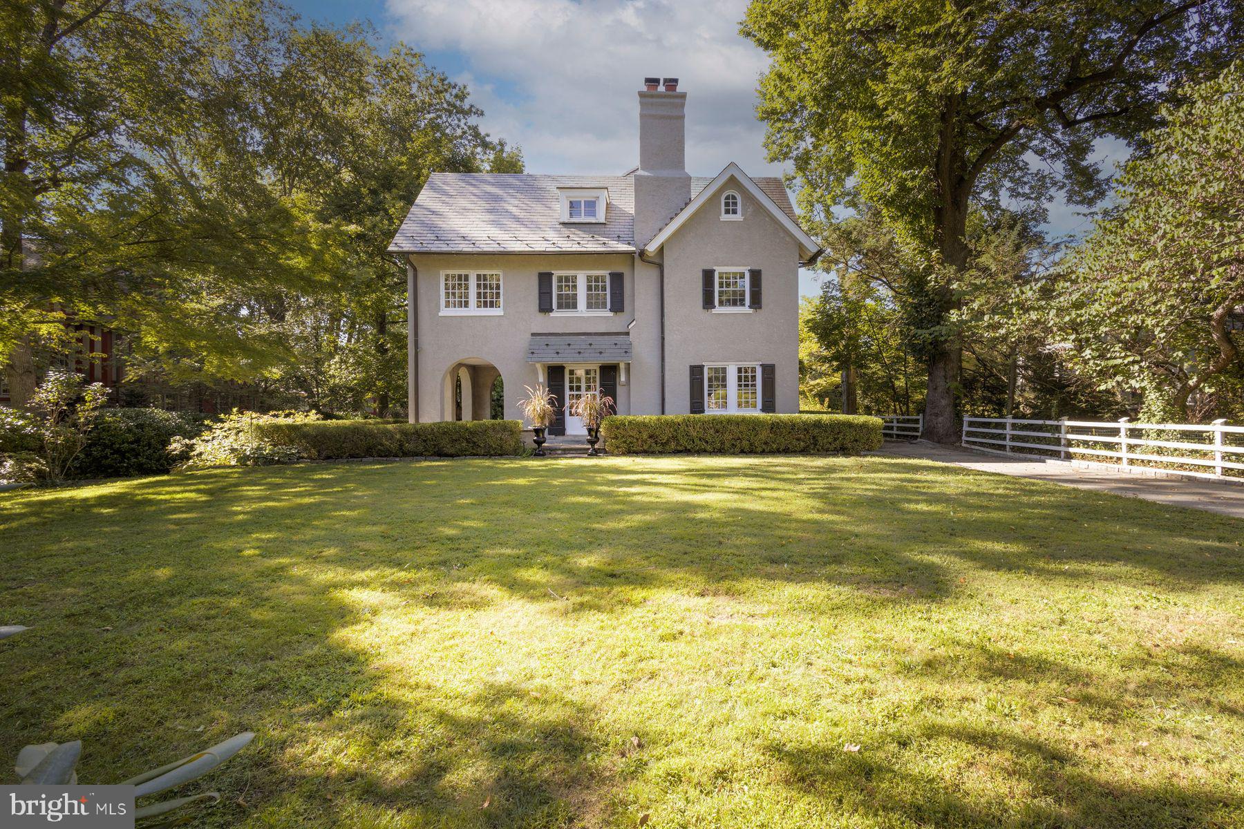 Gracefully Historic, Effortlessly Modern
Welcome to 109 W. Moreland Avenue. This Chestnut Hill charmer blends historic character and contemporary living. Built in 1925, this classic center hall Dutch Colonial-style residence spans approximately 6,770 square feet on a .44-acre lot with 6 bedrooms, 5 full baths and 2 half baths. Lush, mature landscaping surrounds the home, creating a private and welcoming outdoor retreat. The home’s stately masonry facade is topped by a timeless slate roof installed in 2000, capturing the elegance and authenticity of its Dutch Colonial heritage. The exterior is complete with a custom designed 4-car garage with unique loft space and fireplace which was built in 2015.
Inside, original millwork, classic fireplaces, hardwood floors, and a sweeping staircase highlight 1920s craftsmanship. The sun-filled center hall layout includes elegant living and dining rooms, French doors leading to a spacious, multi-level flagstone terrace, designed and built in 2010 by local landscape architect EG Rall and seamlessly connects to a beautiful covered porch with distinct archways.
At the heart of the home is a custom-designed kitchen, completed in 2012, offering both style and function with a spacious central island, sleek countertops, and plenty of cabinet storage space. A connected mudroom offers easy access from the driveway.
The second level features a primary suite with sitting room, walk-in closet with spa-like bath and sleeping porch/workout area. This level is completed with 3 additional bedrooms, 3 bathrooms and laundry room. The staircase continues to the third level which boasts 2 bedrooms/office space and a bathroom. Additional fun and functional family living space is found in the expansive, partially finished basement, ideal for a playroom or a casual hangout spot for teens.
Experience the perfect blend of charm and convenience with this classic Chestnut Hill property, just steps from quaint shops, acclaimed restaurants, the scenic Wissahickon Trail, and with easy access to Center City Philadelphia, Manhattan and Washington, D.C. via train. Don’t miss the opportunity to make this gracious home your own; where comfort, style, and a vibrant community come together to offer a truly unparalleled living experience.