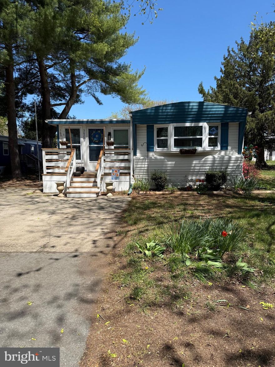 Tastefully decorated single wide modified home in the convenient community of Camelot Meadows. This home has central air, is mostly all drywall with recent beautiful vinyl plank floors throughout. New bathroom vanity, closet doors, pocket door, and barn door. Recently painted. Large Four Season room with sliding doors to deck, fenced yard, with outside shower and shed. Square foot is approximate. Roof resealed recently, and new belly wrap and insulation under home. Most furniture conveys with sale. Community has pool and clubhouse (Membership is optional). Potential buyer must be approved by Park. This is not a ride-by! Make appt and take a look