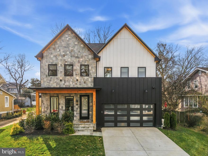 Tucked away on a rare and coveted flat lot on North Jackson Street, this nearly new Clarendon residence offers a refreshingly open floor plan that feels impressively expansive yet remains warm and inviting. The home makes a striking first impression with a clever dichotomy of exterior materials, hinting at the architecturally interesting details found inside—from the ten-foot ceilings and wide-plank white oak flooring to the cathedral ceilings in the primary bath.

At the heart of the home is a gourmet kitchen designed for both high-end entertaining and easy daily living. It features an abundance of cabinet storage, dual dishwashers, and sprawling countertop space, anchored by a 48" Wolf range and Sub-Zero refrigeration. For those who love an indoor-outdoor flow, a dedicated coffee station and wet bar walk directly out to the level backyard and a cozy screened-in porch with a linear stone fireplace. To keep daily life organized, the main level also includes a spacious mudroom and a large attached two-car garage.

The upper level continues the theme of functional luxury. The primary suite is a true sanctuary, featuring a morning coffee bar, two massive walk-in closets, and a spa-inspired bathroom with cathedral ceilings and a dual-head shower wet room. Practicality is woven throughout, including an upper-level laundry room and a unique, sun-drenched walk-in pantry. On the lower level, you’ll find a dynamic sunken recreation room with a built-in homework nook, a dedicated gym area, a theater room, and a full guest suite—making it a versatile space for hosting or relaxing.

The home is as smart as it is beautiful, featuring significant infrastructure enhancements like a standby generator, an irrigation system, and a stacked elevator closet for effortless accessibility across all levels.

Location is everything here, placing you just blocks from the Clarendon and Virginia Square Metros, 15 minutes to the center of DC, the newly renovated Zitkala-Sa Park, and the local dining scene at favorites like Tatte Bakery and The Salt Line. Beyond the home itself, the community spirit on North Jackson Street is a major draw. The block is famous for its legendary Halloween festivities; whether you want to jump in and play along with an over-the-top display or just admire the energy from your front porch, Ashton Heights is the kind of neighborhood that feels like a true community.