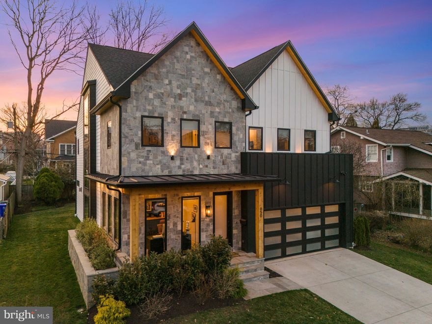 Tucked away on a rare and coveted flat lot on North Jackson Street, this nearly new Clarendon residence offers a refreshingly open floor plan that feels impressively expansive yet remains warm and inviting. The home makes a striking first impression with a clever dichotomy of exterior materials, hinting at the architecturally interesting details found inside—from the ten-foot ceilings and wide-plank white oak flooring to the cathedral ceilings in the primary bath.

At the heart of the home is a gourmet kitchen designed for both high-end entertaining and easy daily living. It features an abundance of cabinet storage, dual dishwashers, and sprawling countertop space, anchored by a 48" Wolf range and Sub-Zero refrigeration. For those who love an indoor-outdoor flow, a dedicated coffee station and wet bar walk directly out to the level backyard and a cozy screened-in porch with a linear stone fireplace. To keep daily life organized, the main level also includes a spacious mudroom and a large attached two-car garage.

The upper level continues the theme of functional luxury. The primary suite is a true sanctuary, featuring a morning coffee bar, two massive walk-in closets, and a spa-inspired bathroom with cathedral ceilings and a dual-head shower wet room. Practicality is woven throughout, including an upper-level laundry room and a unique, sun-drenched walk-in pantry. On the lower level, you’ll find a dynamic sunken recreation room with a built-in homework nook, a dedicated gym area, a theater room, and a full guest suite—making it a versatile space for hosting or relaxing.

The home is as smart as it is beautiful, featuring significant infrastructure enhancements like a standby generator, an irrigation system, and a stacked elevator closet for effortless accessibility across all levels.

Location is everything here, placing you just blocks from the Clarendon and Virginia Square Metros, 15 minutes to the center of DC, the newly renovated Zitkala-Sa Park, and the local dining scene at favorites like Tatte Bakery and The Salt Line. Beyond the home itself, the community spirit on North Jackson Street is a major draw. The block is famous for its legendary Halloween festivities; whether you want to jump in and play along with an over-the-top display or just admire the energy from your front porch, Ashton Heights is the kind of neighborhood that feels like a true community.
