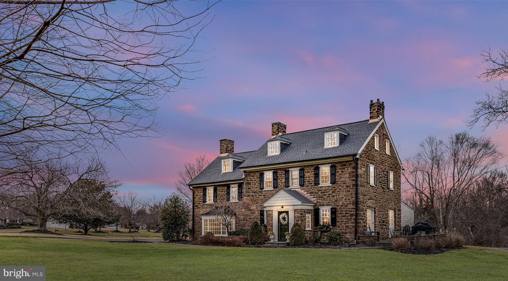 Welcome to historic Lakeview Farm located in Maple Glen. True to its name, the home is nestled on over two acres of beautiful landscapes, an abundance of natural light and overlooks a serene lake. The improvements done over the years have stayed true to the time period of the hallmark construction from the wide beam hardwood floors to the two-zoned central air conditioning. It is evident throughout the home, especially in the kitchen, adorning soapstone countertops, Sub-Zero refrigerator, Heartland stove and oven, and Fisher-Paykel dishwasher; all beautifully complimented by the custom cabinetry. The wet bar area in the kitchen has a handsome copper sink and wine refrigerator. The opulent living room has a fireplace and window with sweeping landscape views fit for Claude Monet. The dining room is perfect for any large feast complete with a walk-in cooking fireplace. There is a home office on the main floor complemented with built-in shelves and unique Prohibition Bar! The mudroom and laundry are conveniently located on the main floor along with a powder room. Follow the red oak stairs to the owner's suite which includes a dressing room, comfortably accommodates king size bed, and private bathroom with heated floors, a clawfoot tub, keeping in touch with the style of the home. The second bedroom has a full private bathroom with a tub and shower. On the third floor there are two additional bedrooms along with another full bathroom perfect for out of town guests or family to have their own space. Beyond the majestic views, there is a four car garage and bonus room with a bar and its own bathroom. Perfect for another home office, home gym or studio for painting, the opportunities are endless and yours to enjoy. The spring house has a well which is used solely for the outdoor sprinkler system. You absolutely can have an authentic farmhouse while still having all of the modern conveniences at your fingertips.