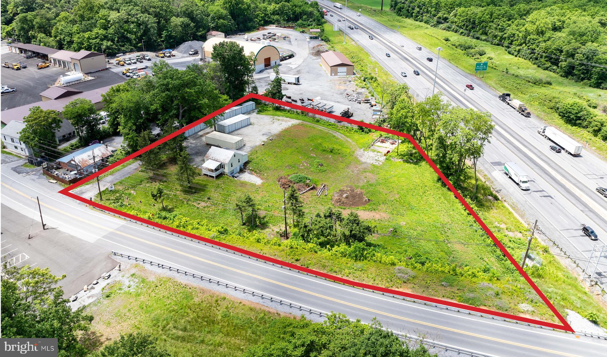 1.67 acres with public water, sewer. Fronts on Interstate 81 and Rock Cliff Dr., Berkeley County Planning Comm. approved for 42 storage units (Currently 5 units in place) and 10 RV pad sites. Signage visible to Interstate 81. 2 Bedroom, 2 bath rental house with full basement, wood and ceramic flooring, new central air, updated wiring and vinyl siding.