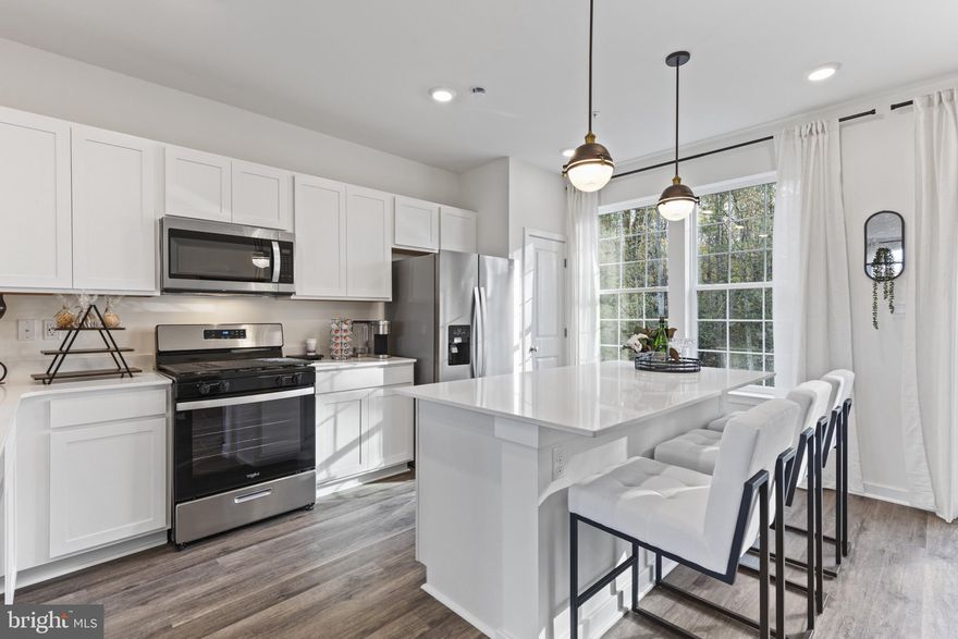 New Home in the PERFECT LOCATION! Backing to trees, this townhome (Available May 2025) features 3 bedrooms, 3.5 baths, a lower level den (that can double as a 4th bedroom) and INCLUDES a 12' x 10' DECK off of the kitchen. Thoughtful design is uniquely embodied in this townhome plan, which features 1,969 sq ft of living space. This home offers a spacious rear main level eat-in kitchen with upgraded white cabinets, quartz countertops and stainless-steel Whirlpool appliances. Recessed lighting and blinds are provided throughout the home as well.  Hard surface flooring throughout the entire home offer modern luxury and contemporary appeal. The third level features a luxurious primary suite with a large walk-in closet and a spacious double vanity primary bathroom.  Two secondary bedrooms, upper level laundry, and hall bathroom which also includes upgraded white cabinets and a quartz countertop. There is plenty of space for entertaining family and friends in your finished lower level den leading to your private backyard. Simplify your life with D.R. Horton's smart home technology which includes a keyless entry, Skybell (video doorbell), programmable thermostat to adjust your temperature from your smartphone and much more! Commuting and traveling are made easy with quick access to Routes 301, 5, I-495 and the Washington DC area.  Conveniently located across the street from tons of shopping and entertainment options. Incredible rates and closing incentive options available with the use of DHI Mortgage.