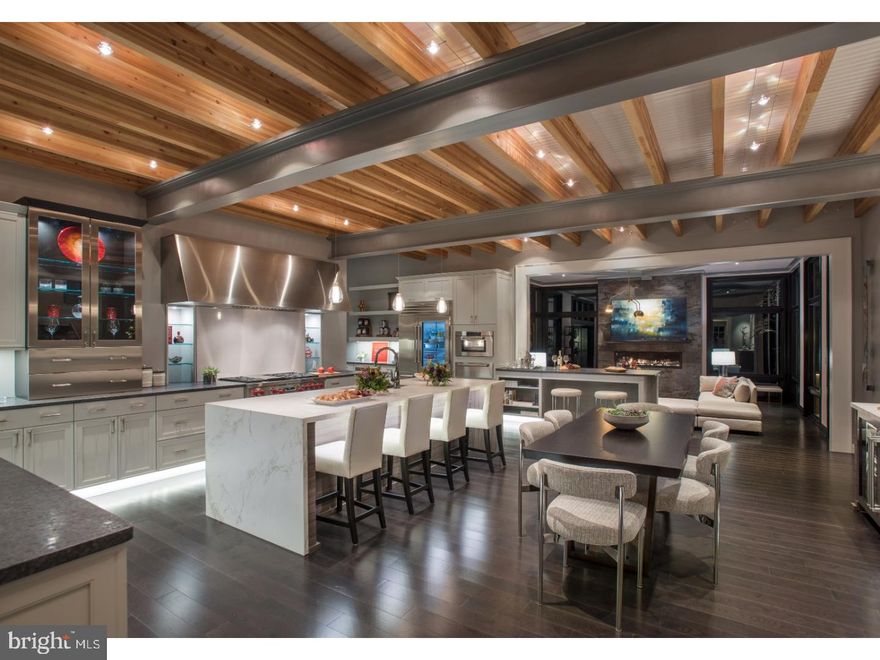 "Wynnewood meets Fifth Ave"..... as 424 SYDBURY LANE embraces the rich architectural heritage of the lower Main Line while it is infused with modern touches creating the 7,231 square foot masterpiece that it is today!! This "one of a kind" stunning home and property was recently completed by Weiss and Associates and its unique design is a totally fresh look with a sophisticated floor plan that embodies open spaces, entertaining and is one with nature. English Normandy architectural details of steep roof pitches, rounded conservatories, and prominent chimneys are effortlessly blended with the newest sleek and smooth materials of glass, limestone, stainless steel, and polished concrete. From the moment you enter you continue to feel in harmony with the outdoors as a glass curtain allows unobstructed views of the woodlands beyond while the interior natural colors of wood, chocolate brown, black and cream blend together and create a feeling of serenity. The First Floor modern day  plan with 10 ft ceilings (12 ft in Family Room) embodies a sense of spaciousness without feeling cavernous as the Piano Lounge, Entertaining Bar, Family Room, Dining Room, and Outdoor Living Room seamlessly blend together into spaces that are stylish, comfortable and functional. These imaginative spaces are grounded by the centrally located showcase Kitchen through an ideal marriage of modern design and traditional living. Stainless steel and granite surfaces combine with the natural elements of a dramatic ceiling featuring exposed structural beams and cable tech lighting creating a spacious and multi-tasking space. A three story open riser graphite staircase with stainless steel balusters leads to the Second Floor where an exquisite Master Suite is set amidst the treetops with private balcony, and "his" and "hers" luxurious and creatively designed spaces can be enjoyed. Three additional generous sized Bedrooms with two full Baths and Laundry Room complete the Second Floor. Flexible finished space with a private outside entrance is perfect for guests, in-laws, au-pair, or office needs. This magnificent property was honored to be the 2017 Philadelphia Design home, as Weiss truly created a fine piece of art in one of Lower Merions  most storybook settings.  For further information log into 424sydbury. Additional 1.5 acreage available for sale next door  and/or different custom home that has been designed and is in permitting stage. Address: 425 Sydbury (MLS # 7080845)