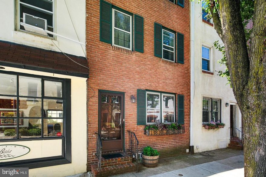 A tremendous opportunity to own a townhouse at the cusp of two top neighborhoods: Rittenhouse Square and Graduate Hospital. 1702 Lombard Street offers 4 levels of living space with modern appointments. Enter into an open front living room featuring hardwood flooring, a brick fireplace, recessed lighting, and crown moulding. The living room flows into the open kitchen, which offers granite countertops, stainless steel appliances, and a subway tile backsplash. Just beyond the kitchen are sliding Pella glass doors that lead to an oversized brick patio. The continuity between the kitchen and patio makes summertime BBQs a breeze! Back inside, follow the stairwell up to the second level which houses two bedrooms, closet space, and a white subway tile bathroom. The third level is home to the king-sized primary suite with a half-vaulted ceiling, two closets, a wonderfully updated primary bathroom with marble flooring, and a bonus linen closet. Be sure to check out the lower level, which is fully finished and provides convenient flex and storage space. An additional room off of the basement could serve several purposes: a media room, office, or studio. A laundry closet with a stacked washer and dryer and additional closet space completes the lower level. The perks of living at this address are countless! Locals enjoy the Schuylkill Banks trail and dog park, top restaurants in Rittenhouse Square, charming cafes in Graduate Hospital, several grocers, and quick access to I-76 and I-676. This location also offers convenient access to the University of Pennsylvania, CHOP, and HUP. Schedule your visit today! Disclaimers: The listing photos are from 2018; there may be some variation between the photos and the current condition. The second-floor office desk is no longer mounted to the wall; a basement photo has been virtually staged. Brokerage and salespersons do not guarantee property tax or square footage data, which should be independently verified by the buyer and their agent.