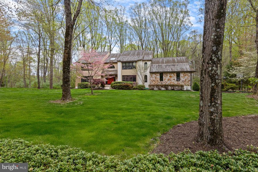This home has all of the charm and privacy of a mountain retreat yet enjoys close proximity to shopping and local businesses as well as Unionville-Chadds Ford schools. Set in the quiet and desirable neighborhood of Waterford, this 1-acre property affords long setbacks and wide spaces between houses. The mature trees line this quiet street. Enter this 4BR, 3.1 bath home and immediately notice the wood floors that run throughout much of the main level as well as the large 2-story foyer with turned staircase. To the left is a large living room with fireplace and window seat. Continue through pocket doors to the office with built-in shelving. Another set of pocket doors leads to the massive 2-story family room with stone fireplace, picture windows and access to the sprawling Trex deck. The rear of the house overlooks lush, wooded space creating the perfect atmosphere for rest and relaxation. Continue on to the large eat-in kitchen with quartz counters, breakfast area and island with seating. A formal dining room is located off of the kitchen and foyer. A convenient laundry room, powder room and access to the large screened-in porch and 2-car garage complete the main level. Head upstairs to find the primary suite with large bedroom and updated en-suite. Three additional well-sized bedrooms share an updated guest bath. The finished lower level walk-out is perfect for relaxing and entertaining. A media room with large windows allows for loads of natural light and leads into a billiards room with built-in bar. An additional room with fireplace and patio access would create a perfect in-home office. This scenic oasis has been lovingly maintained and is ready for its new owners!