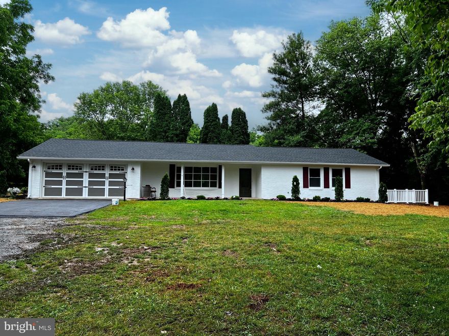 5 acre residential rural property in a wonderful location 15 minutes from Charles Town or Shepherdstown. This lush  level equally wooded and open meadowland acreage is enclosed on all sides and shaded throughout the amazing property by plentiful groves of tall mature trees, including Oak, Dogwood, Pine, walnut, and more on a stunning piece of land with its gracious meandering tree lined drive up to a completely updated  home. The  home is a 4 bdrm 4 1/2 bath, fully finished basement, 2 car attached garage ranch style brick home which sits in its perfect private location on the land and includes a huge 27’ x27’ drive-through equipment barn with covered side storage area the length of the building. The classic brick ranch house with its large finished bsmt  includes a modern open floor plan : living room, dining room, large kitchen with island, upgraded stainless appliances including built in food warming drawer , sliding doors to  patio,  separate laundry room w half bath.  There are three primary bedrooms on the main living level. The land itself is a 5 acre treasure of mature trees, plus open spaces of grass meadowlands, woodland pathways in a flat desirable building location with No HOA and close to services as well as being peacefully privately rural in nature. Rare extraordinarily beautiful property sure to intrigue those who wish for rural living with close proximity to town w acres of space to enjoy country living