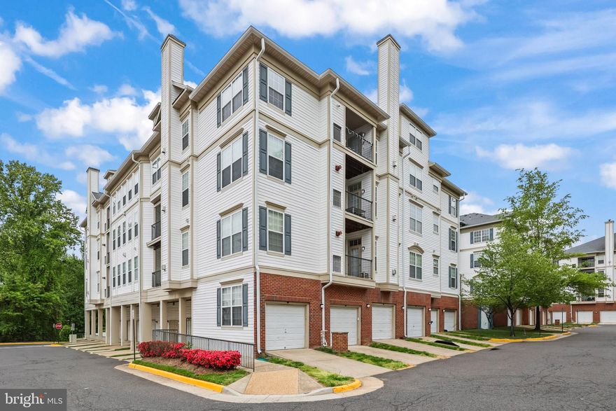 You’re going to love this move-in ready 4BR/3BA condo — it feels more like a single-family home. With 1,760 sq ft across a dramatic two-level layout and cathedral ceilings, the space is bright and airy thanks to large windows and an open, functional floor plan. Imagine cooking at the large island with quartz counters while still being part of conversation in the living room, which has a cozy fireplace and a balcony. The main living areas have elegant engineered flooring, and two guest bedrooms are carpeted for comfort. The kitchen was thoughtfully renovated with full-height cabinets, a custom backsplash, and all-new appliances. The primary suite is a real retreat: a custom bathroom with a walk-in shower, designer tile, water jets, linen cabinet and quartz counters. All toilets are new chair-height and every light fixture was recently replaced. The whole place is freshly painted in Benjamin Moore Metropolitan Grey. Practical perks you’ll appreciate: in-unit stacked washer/dryer, a new hot water heater, recessed lighting, on-site trash/recycling, and an oversized individual garage with its own driveway for extra storage and parking. The building is on the 4th floor with elevator access and also features a separate, easily accessible entrance designed for wheelchair access. Outside your door you can walk to the community pool, clubhouse with exercise room, tennis courts, tot lots and trails — and you’re just minutes from Wegmans, Costco, major shopping, and commuter routes like I-66, Routes 50 and 29 and Fairfax City Parkway. This is rare square footage in today’s market — if you want a bright, thoughtfully updated home that combines convenience and comfort, this could be the one.