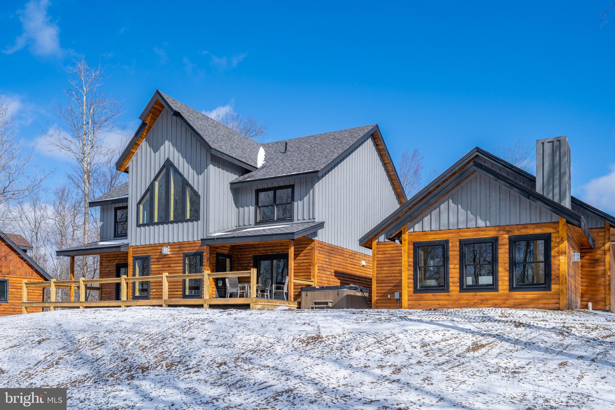 Luxury Log Home on Lodestone Golf Course – This brand-new 6 bed, 6 + 2 half bath log masterpiece delivers nearly 6,000 sq ft of pure elegance, finished in 2025 with a seamless blend of modern luxury and rustic charm. Nestled right along Hole #6, it offers a front-row seat to Deep Creek’s most scenic fairways. Open-concept great room that stuns with soaring ceilings, stone fireplace, and towering windows that flood the space with natural light. A loft above adds to the grandeur, offering the perfect overlook. Stunning chef’s kitchen adorned with leathered granite tops, island bar, and a butler’s pantry hiding a secret passage to the mudroom for effortless grocery drop-off. Each ensuite bathroom is a showpiece, wrapped in sleek tile with spa-like showers. Seperate living space just off the hot tub patio, complete with its own fireplace, is the owner’s favorite retreat! Sprawling rec room above the oversized heated garage. Finished basement offers a home theater, game room and private den with 3rd fireplace. No shortage of outdoor space with over half an acre of wooded land and a wire-railed deck that invites in the surrounding beauty. Modern decor throughout and sold turn-key - Fully Furnished. Minutes from Deep Creek’s best restaurants, marinas, parks, and Wisp Resort, this one is the total package—luxury, convenience, and mountain magic all wrapped in one. Call today for your private tour!