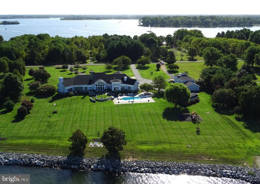 Stunning estate minutes to the Chesapeake Bay Bridge.  Attention to detail found at every turn.  Over 5 acres on Eastern Bay with beautiful sunsets and waterviews every where.Master suite with his and hers closets, fireplace and walk out to private patio.  Three additional bedrooms with ensuite baths.  8 seat home theater with private  bath and bar area.  Gourmet kitchen with large island and butler pantries. Smart home system, geothermal HVAC system, and  many more upgrades.  Full basement with lots of storage.  Three car attached garage AND a large detached garage with space for numerous cars, an RV or boats.Two deep water slips on the Wye River on the community pier- just minutes from the house.This is what living on the Eastern Shore is all about.