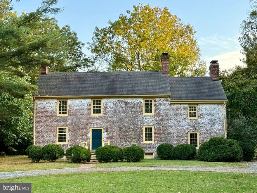 Originally built with handcrafted bricks in 1782, this Flemish Bond Georgian Colonial home is the embodiment of simple elegance. Restored with the utmost historical respect in the mid-1980’s with handcrafted oak windows and mahogany doors with period hardware and modernized with preservation-sensitive practices and materials over the past eight years by the current stewards of the home, step into the past while enjoying today’s comforts.

The four-bay home has a traditional floor plan with the living and dining room flanking the center hall, a large sunken family room anchored by the massive hearth – reconstructed with original bricks from the 1782 structure and walnut mantel, and a kitchen and sunroom addition on the back of the home, added between the mid-80’s and early-90’s. The kitchen was afforded another renovation around 2008 with high end finishes and an open, welcoming concept ideal for functionality and entertaining.

Follow the original staircase upstairs, running your hand along the centuries old banister to two of the bedrooms which share a generous bathroom off the second story landing. Closets have been incorporated in the landing and bedrooms to allow for modern storage solutions, all while using period specific paneling and hardware to replicate the historic aspects of the original design scheme of the 1790s. The primary suite wing, accessed by its own staircase, consists of a one-bay bedroom, dressing room with laundry, and an en suite bath overlooking the rear yard. Each bedroom has its own fireplace, where the gentle crackle of the flames offers a retreat from the modern world, inviting guests to appreciate simpler times and the charm of a bygone era.

Modern comfort conveniences including two year new HVAC units, preservation-sensitive insulation, professionally restored windows with new storm windows, and two brand new woodstoves round out the incredible features that make this home low maintenance and turn-key.

The studio barn, accessed by its own gravel drive and parking pad, is a two story, two bay garage, with an interior but separate workshop. Since 2018 it has been insulated, drywalled, painted, had its own dedicated water, high-voltage electric, and fiber optic internet lines run, and had a pellet stove installed.

Situated on 6.8 serene acres, the grounds have a mature boxwood hedge, a perimeter of pines, fallow pastures which fill with wildflowers throughout the summer, wandering paths to birdwatch, and scattered perennials which pop up each spring with a burst of color and personality.

The home has a rich history dating back to the earliest settlements of Maryland. The namesake of the road upon which it sits, the home was built by the Lamb family who settled in the area in the 1600s, purchasing land from the area Native Americans. The Lambs went on to divide the farmland, constructing many homes built in the same period for their descendants including this one, the best-restored home of the Lamb houses. The Hepburns (actress Catherine Hepburn’s family) and the Bowers are part of the same local family. The local Library has a detailed reference book on the history of the Family.

Friendship was constructed by Daniel Lamb in 1782 – the same year Washington College in Chestertown was founded. The original house was a four-room, split-level house. You can see “DL 1782” in the date brick that was salvaged when the chimney was reconstructed in 1985. Ten years later, his nephew went-on to construct the east wing of the house to complete the center-hall colonial you see today. The 1792 date brick for this addition for this addition can be located between the two windows on the east-wall exterior: “H DL 1792” for Harriet Bowers and Daniel Lamb. You can find Harriet’s signature on the ceiling beam of the center bedroom.