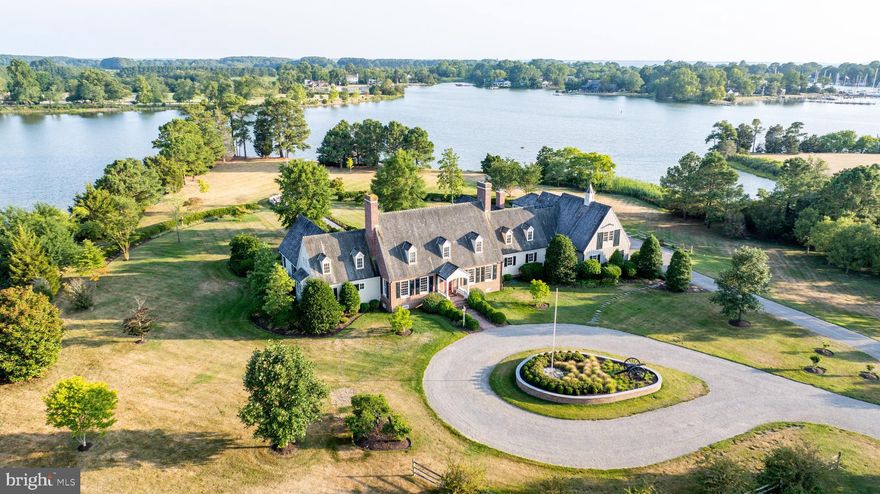 Nestled on 4.43+/- acres at the confluence of Town ​Creek and Cemetery Cove, this exquisite property ​offers an unparalleled waterfront living experience. ​Boasting 1,039+/- feet of waterfrontage with 5+/- ​feet of Mean Low Water, you'll relish the gorgeous ​southern exposure views from almost every angle.
The waterside main-level primary suite features high ceilings, built-in bookcases and spacious walk-in closets, while the upper level houses four additional en-suite bedrooms, perfect for family and guests, as well as an office/playroom with a built-in desk, exposed ​brick details, built-in bookcases and skylights providing a versatile space for work or play.
The family room, located just off the kitchen, is a cozy retreat with a brick fireplace, vaulted ceilings, and ​exposed beams. For those who love to read, the library with built-in bookcases offers a serene escape.
The kitchen is a chef's dream, featuring a large island, Wolf gas stovetop, and double-wall oven. The sun-​drenched hallway, with water views, patio access, and brick radiant heat flooring, connects the living spaces ​and invites you to bask in natural light.
Outdoor amenities abound, including an in-ground pool, a detached 3-season pool sunroom, and a pier with a ​boat lift. The property also includes a 2-car attached garage and a 1-car detached garage, providing ample ​space for vehicles and storage. This exceptional home combines luxury, comfort, and breathtaking views, making it the perfect retreat for ​discerning buyers.