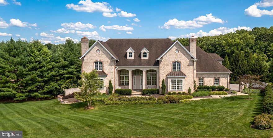 Bathed in golden sunlight throughout, this handsome home presents soaring ceilings, gorgeous classic millwork, simply glowing hardwood floors and the perfect floorplan for both your next soiree or lacrosse practice night.  Generously-sized living spaces include a main level study, large kitchen with breakfast area and full butler pantry, main level owners' suite with jacuzzi bath and dual walk-ins plus 3 cozy gas fireplaces. The versatile upper level offers 4 additional bedrooms with option for a formal library, upper level laundry and a bonus room/den!  The spacious walkout lower level features fabulous flexible recreation spaces including a 6th bedroom, theater/media room, exercise center plus billiard area and wet bar.  This idyllic property boasts pastoral views and abundant privacy while offering incredible convenience to area attractions and services.