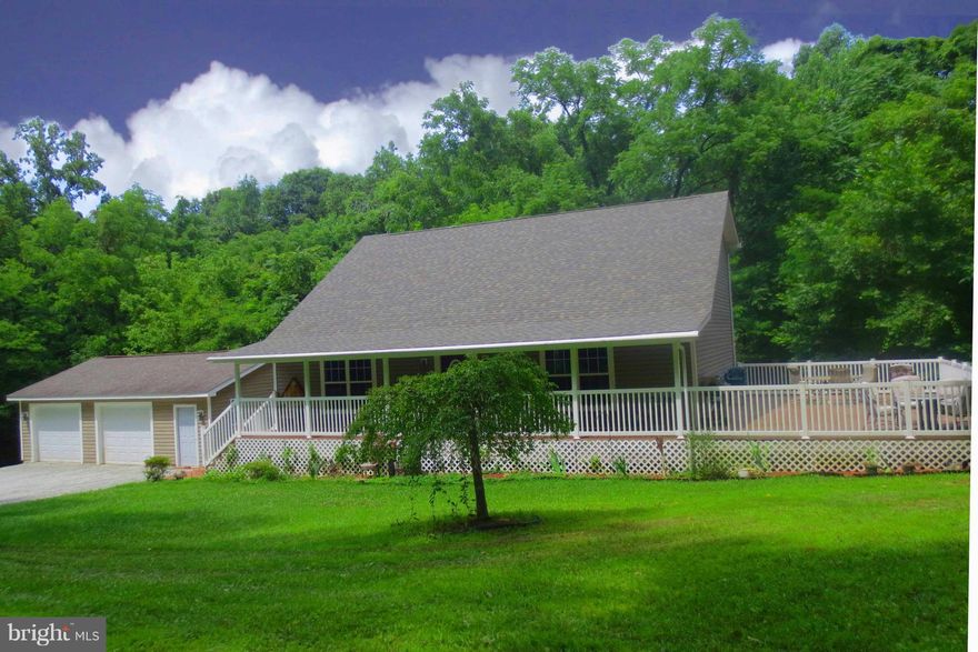 Escape to nature in this secluded hideaway perfect for entertaining with spacious rooms. Eat in kitchen with quartz countertops, island and bar stool counter.  Dining room off kitchen . Main level master bedroom includes laundry room off large walk-in closet. Partially finished walkout basement with in wall surround sound. Wrap around porch opens to large deck .  Free boat launch end of street!