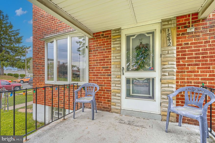End-of-group brick rowhome on a spacious corner lot in the Eastfield neighborhood of Dundalk! Offering 3 bedrooms, 1.5 baths, and over 1,800 total square feet, this home features a covered front porch, bay window, and original hardwood floors in the living room. The large dining room includes a full wall of built-in cabinetry, adding charm and functionality.
The partially finished basement offers additional living space, new carpet, a half bath, and a rear walkout to the backyard. Washer and dryer are included, along with ample storage throughout.
Outdoor features include a covered rear patio, gazebo, above-ground pool, and a large shed—all within a generously sized fully fenced yard rarely found in this area. Driveway space exists at the rear of the property, currently utilized as outdoor space.  Conveniently located near CCBC Dundalk with nearby walking access, plus plenty of street parking along both the front and side of this corner lot.
A great opportunity to add your personal touch and build equity! Sold As-Is, inspection for informational purposes only.