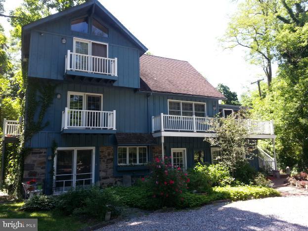 This charming three-story home is ideally located just a short walk from the lively center of New Hope Borough, where you can enjoy a variety of shopping, dining, and entertainment options. The property sits on a good-sized lot, offering a nice balance of space and privacy. The main level features a cozy screen porch that leads to the scenic trails of Delaware Canal State Park. Inside, the open-concept living and dining area includes a cathedral ceiling, large windows, and French doors that provide picturesque views of the Delaware River and canal. The second floor includes a loft area with access to a rooftop deck, perfect for enjoying the outdoors. The bedrooms are spacious with high ceilings and ample closet space. The master suite offers a peaceful retreat with lovely water views, making it an ideal spot to enjoy morning sunrises. The first floor includes a separate two-bedroom apartment with its own private entrance. This flexible space, featuring exposed river stone walls and its own laundry area, can serve as a rental unit, home office, or guest suite. The property also offers a detached two-car carport and additional parking for multiple vehicles. More details can be found in the seller's disclosure and attached documentation.