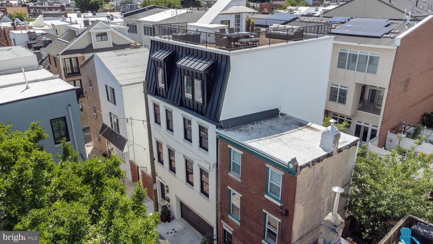 Welcome to 620 Clymer Street, in the city, yet fully immersed in nature, designed down to the smallest detail by an interior designer and luxury contractor team. Nestled down a hidden lane with only one way in, you will find this gem standing at 25' wide, with 3500 square feet of luxurious living, three outdoor spaces, one car parking garage, and so much more to offer in the Meredith School District.  Enjoy the peacefulness of  privacy this street has to offer as you gaze out at the largest magnolia tree in Philadelphia outside of Bartram Gardens.  
This home was approved to be 40' high, leaving large ceiling heights throughout. Sprawling 5 floors with 10.25” European white oak engineered hardwood flooring and roof deck featuring  900SF IPE wood tiled roof deck with 360-degree views of the city.  
As you walk through the checkered tile foyer, find ample storage and a coat closet located in the back foyer before you head out to a quiet tree lined, flagstone backyard with large trees and up lighting.  
On the lower level, a full room to use as a guest room or workout area with full bathroom makes for great extra space.  Make your way up from the foyer to the main level, where you will spend your time in the massive designer kitchen entertaining or enjoying a cozy night by the fireplace. The open floor plan incorporates the living room, outside patio, dining area and kitchen featuring a 14' beautiful quartzite island, Wolf range, and designer custom cabinetry .  On the third floor there are three well-appointed bedrooms with great closet space in each, a full bathroom, and laundry room with sink and counter space.
The top floor reveals a Primary Suite beyond compare, an entire floor of the home. The bedroom has expansive views of the city, elaborate moldings, dry bar, speakers, an ultra-luxury en-suite bathroom and TWO cavernous walk in closets.  
Up to the expansive designed roof deck where you can watch the fireworks and views of city skyline and both bridges.   Roof was designed to entertain with wiring for sound, electric, and water.   For a complete list of upgrades and features see the attached document.
ALL THIS AND ALMOST 9 YEARS LEFT ON TAX ABATEMENT!