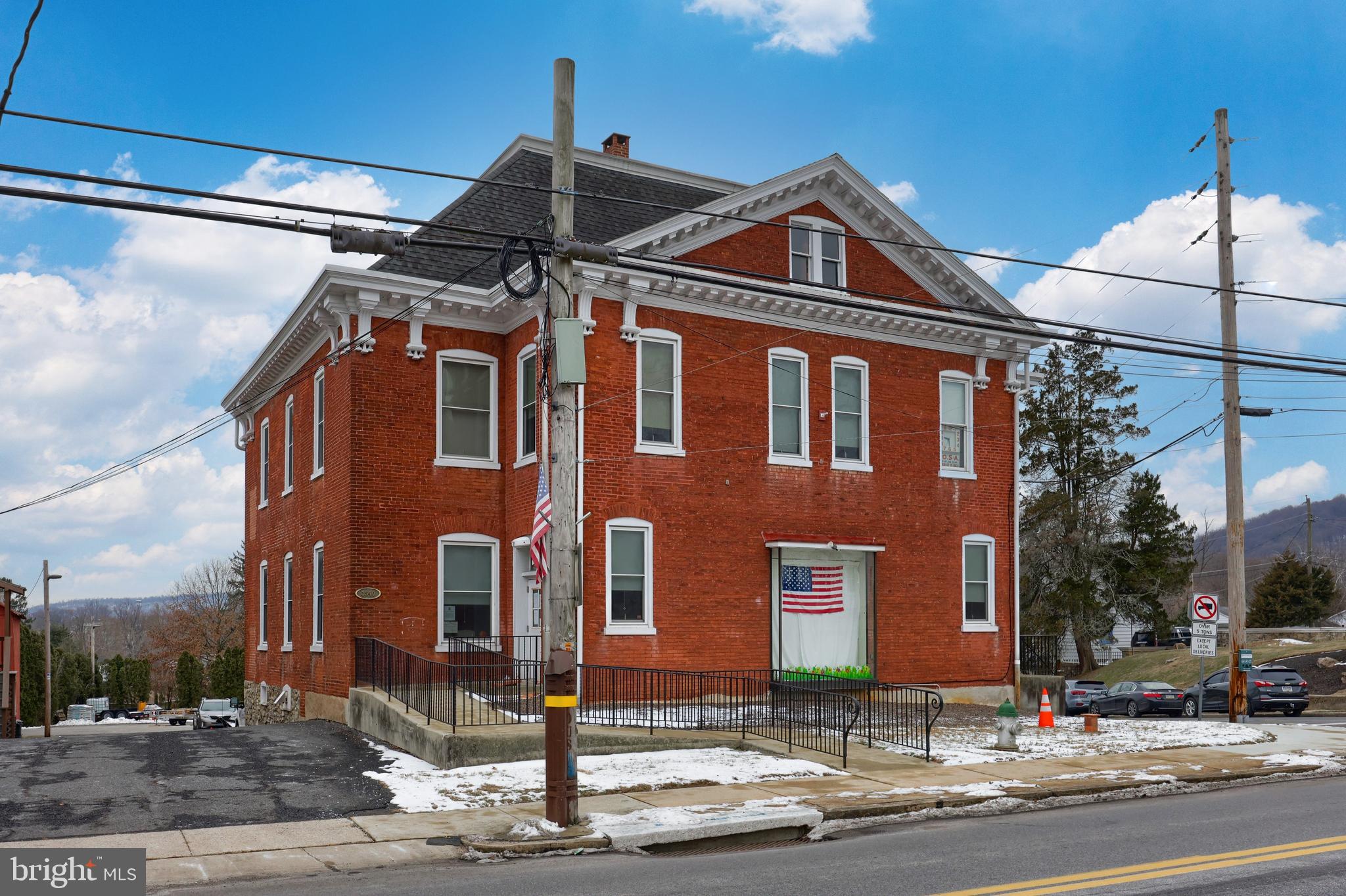 Former St. Lawrence Borough Hall. this property features 2 floors plus a walk-out lower level. Each of the floors is accessible via elevator. The sale includes the additional land parcel in the rear that provides additional paved parking, bringing the off-street parking to a total of 21 spaces.