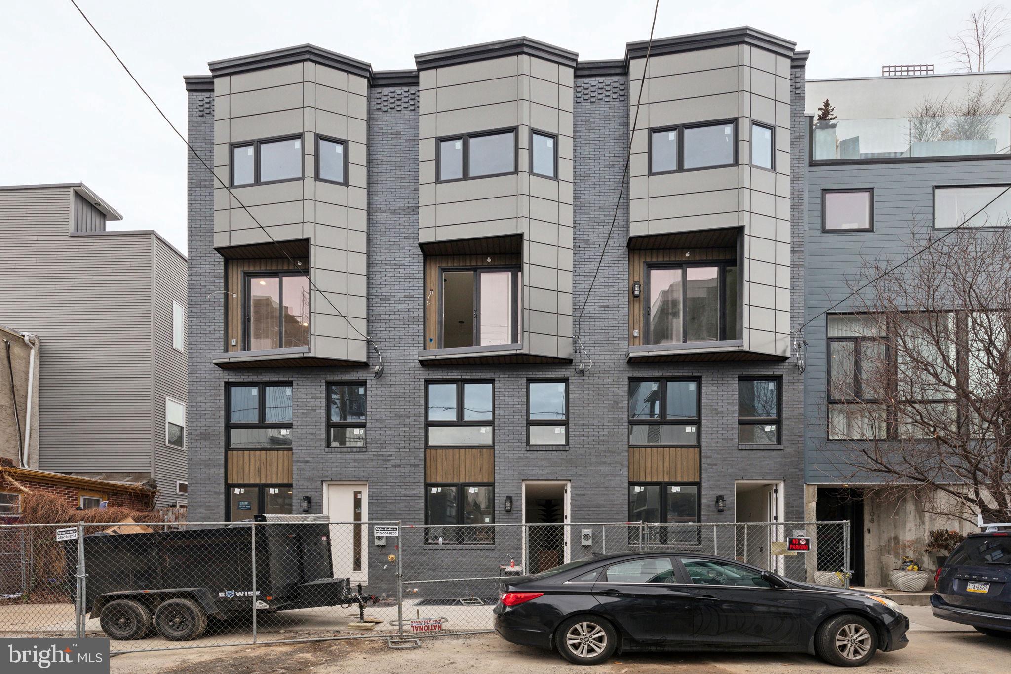 Welcome to The Bodine Three, a collection of three stunning new construction townhomes in the heart of Northern Liberties. Perfectly situated just steps from 2nd Street, The Piazza, and One Shot Coffee, these meticulously designed residences offer contemporary elegance, spacious layouts, and premium finishes—all in one of Philadelphia’s most sought-after neighborhoods. Step inside to experience sun-drenched interiors with soaring ceilings and expansive open stairwells that enhance natural light flow. Throughout the home, you’ll find wide-plank white oak flooring, adding warmth and sophistication to the modern design. The thoughtfully designed second-floor catwalk adds a dramatic architectural touch, offering an elegant view overlooking the dining space below. Extra-high basement ceilings create a bright and airy feel, perfect for additional living space, a home gym, or a media room. Each bedroom in The Bodine Three enjoys the luxury of a private floor and an en-suite bathroom, ensuring privacy and comfort for every resident. The primary suite is a true retreat, featuring a spa-like en-suite bath with a luxurious soaking tub, perfect for unwinding after a long day. On the fourth floor, a bonus flex space awaits—ideal for a cozy sitting area, a home office, or a reading nook. Step outside to the large private back patio, perfect for entertaining or relaxing. Finally, make your way up to the rooftop deck, where you'll be captivated by panoramic city skyline views, creating the ultimate urban oasis. With a 10-year tax abatement, high-end finishes, and an unbeatable location, 1106 N Bodine Street is a rare opportunity to own a masterpiece of modern design in one of Philadelphia’s most vibrant communities. Don’t miss your chance to own one of these exceptional homes—schedule your private showing today!