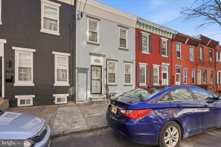 Welcome to 2033 N Mascher Street, a stunning fully renovated 2-bedroom, 1-bath townhome nestled in the heart of the vibrant Norris Square neighborhood of Philadelphia. This home exudes modern elegance with a perfect blend of contemporary finishes and timeless charm. Step inside to an open floor plan that’s ideal for both daily living and entertaining. The living room boasts a sleek electric fireplace, creating a cozy ambiance, while gleaming hardwood floors and ceiling fans enhance the comfort and style throughout the home. The combined living and dining area seamlessly connects to the well-appointed kitchen, featuring stainless steel appliances, a chic white subway tile backsplash, and counter space, perfect for culinary enthusiasts. The private, fenced-in rear yard is your personal retreat, providing a serene space to relax, entertain, or simply enjoy the outdoors. Upstairs, you'll find two good sized bedrooms, each offering generous closet space with built-in shelves for convenient storage. The modernized full bath adds a touch of luxury with updated fixtures and finishesThe partially finished basement offers a dedicated laundry area with a washer and dryer, along with concrete flooring, providing a versatile space that can be used for storage or easily transformed into a home office, workout area, media room, and more. This home comes equipped with a video surveillance system and a Ring camera for added peace of mind. Situated just steps from Norris Square Park, you'll enjoy easy access to green spaces, popular restaurants, shopping, and public transportation, making city living as convenient as it is exciting.