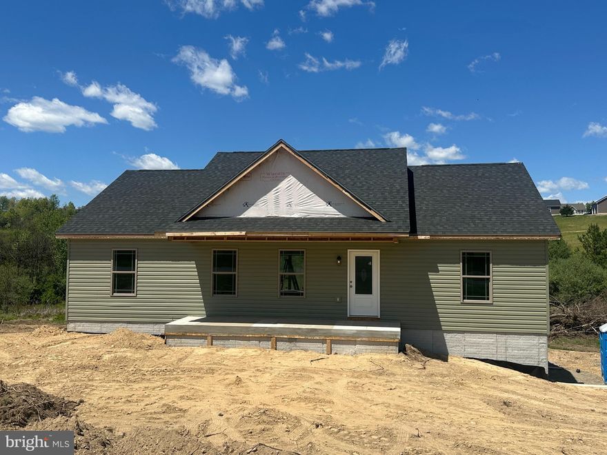 More Photos Coming Soon! Beautiful nearly completed 5-bedroom, 3 full bath ranch home situated on 2 peaceful acres near the Virginia/West Virginia border, just a short drive to historic Winchester. Offering 2500 finished square feet, this spacious home features an open-concept floor plan designed for comfortable everyday living and entertaining.

The main level includes a large living room, dining area with decorative shiplap accent wall, and a stunning kitchen complete with granite countertops, center island, and oversized breakfast bar. The private primary suite offers its own full bath along with his-and-hers walk-in closets. Two additional bedrooms and another full bathroom complete the main floor.

The fully finished walkout basement provides incredible additional living space, including 2 more bedrooms, a large family room, and a full bathroom — ideal for an in-law suite, guests, or multi-generational living.

Additional highlights include a finished 1-car garage, spacious front porch, and a large rear deck perfect for entertaining, family gatherings, or summer BBQs.

Escape the city and enjoy peaceful country living with modern comforts and easy commuter access. With in 15 minutes to Grocery stores, shops, and restaurants. Expected to be move-in ready in early to mid-June! Checkout this home before it's too late!!