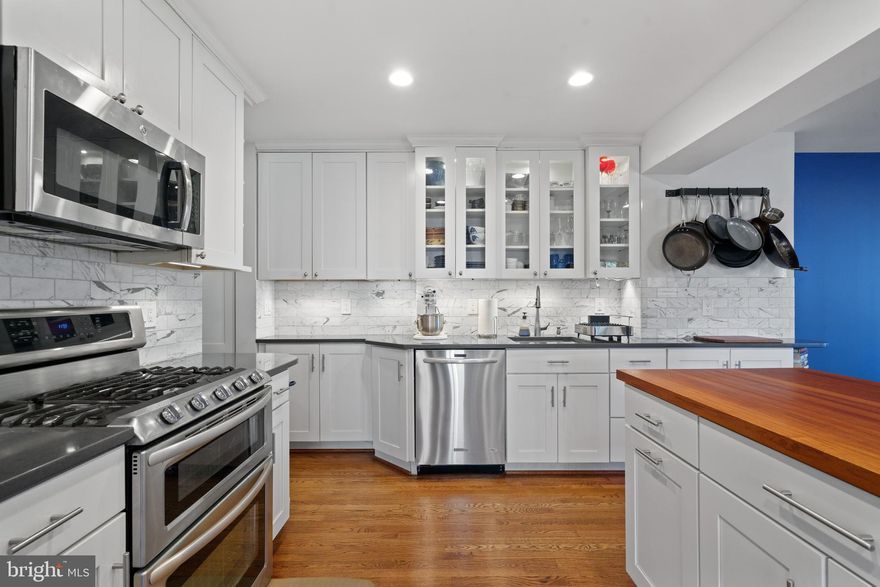 This charming 3-bedroom, 2-bath home in south Arlington offers a unique blend of comfort, convenience, and natural beauty. Unlike most homes in the neighborhood, this one features a stunning remodeled kitchen and a spacious living/dining room addition—perfect for entertaining. The layout includes two bright bedrooms upstairs with a full bath, while the sunny basement-level bedroom has its own full bath. The front room, currently a cozy family room, doubles as an office with built-in shelves, a TV closet, and a gorgeous bay window overlooking a park with a creek. There are storage shelves in basement utility room, external storage in crawl space, and more storage in the attic! The fenced backyard boasts a lovely patio, plenty of space for a large dog, and two Japanese maples—one recovering beautifully from storm damage and another adding seasonal charm to the front yard. The stone-paved driveway adds to the home's curb appeal, and street parking is never an issue. Practical upgrades include a new roof (2021) and a new washer/dryer (2024). The location is unbeatable— just 0.3 mile(s) to Giant Grocery, a vet, Gold’s Gym, two fantastic restaurants, and other amenities. Four Mile Run Park, with its extensive running and biking trails, is right across the street, while Shirlington’s theaters, shops, and dining are less than 1.5 miles away. Commuters will appreciate the easy access to two metro stations, and the Potomac River bike trails also close by. This property is zoned for Wakefield High School. With 1,900 sq. ft. of space in this sought-after neighborhood, a fenced yard, and stunning views of greenery, this home truly is a rare find!