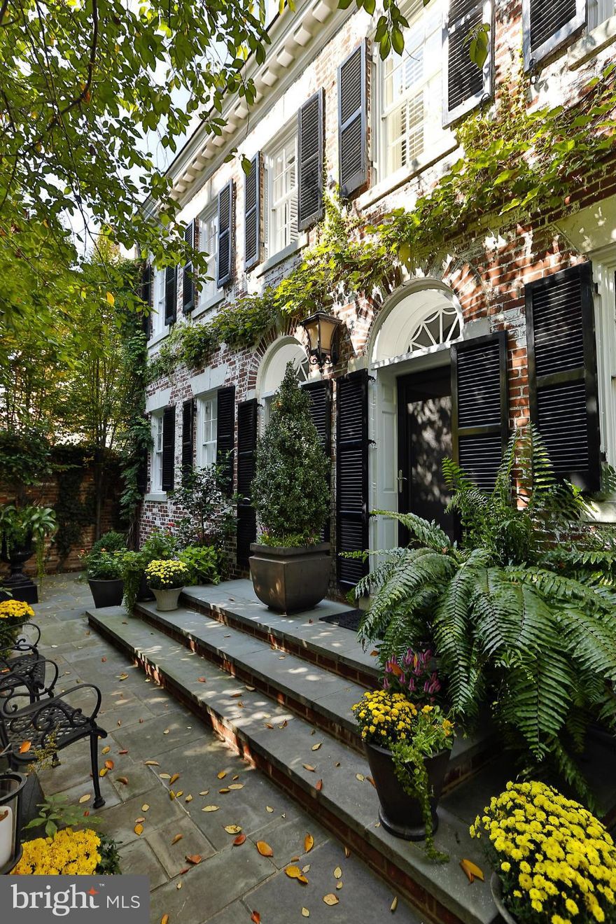 This elegant white washed Federal style home is concealed and enclosed within a secure brick wall in Georgetown's prime East Village. The fully detached home was artfully renovated in 2005-2006 to the highest standards and quality finishes. Private gardens with 3 fountains. The home offers 7 bedrooms, 6 of them en-suite, 7.5 baths, three kitchens and an elevator.