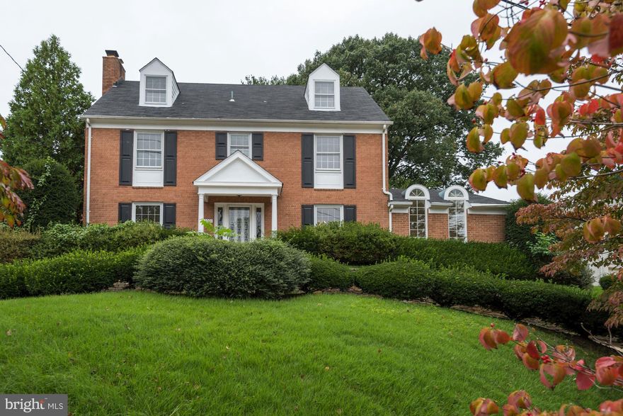 INCREDIBLE VALUE!!! WALK TO METRO! THIS BEAUTIFUL HOME DOES NOT FEEL LIKE A MAIN ROAD,  ENTRY TO DRIVEWAY IS ON CEDAR WAY AND THE H OME IS SITED VERY HIGH ON A CORNER LOT MAKING FOR A VERY STATELY PRESENCE.  Huge,  all brick colonial - 4 levels, 3500+s square feet, hardwood floors on main and upper level 1.  One of the most light filled listings active now - its impossible to be in a bad mood in this sunny house!   Oversized windows, wood burning fireplace in big living room that walks out to the patio and backyard.  Big Dining room, gorgeous sun room addition with huge windows with transoms,  big eat-in kitchen - with new SS refrigerator, and dishwasher and new range and range hood.   2  Master Suites (upper level 1 and 2), both with  walk-in closets & full baths.   Finished lower level with half bath and bedroom #5, rear door to steps up to back yard.   Tucked away fenced rear yard, 2 car detached garage, parking in driveway for 2 PLUS circular driveway and parking along Cedar Way - this is an absolutely fantastic opportunity to make this your forever home - there is nothing this substantial on the market in Bethesda under $1 million walking to Metro.   Sold As Is.