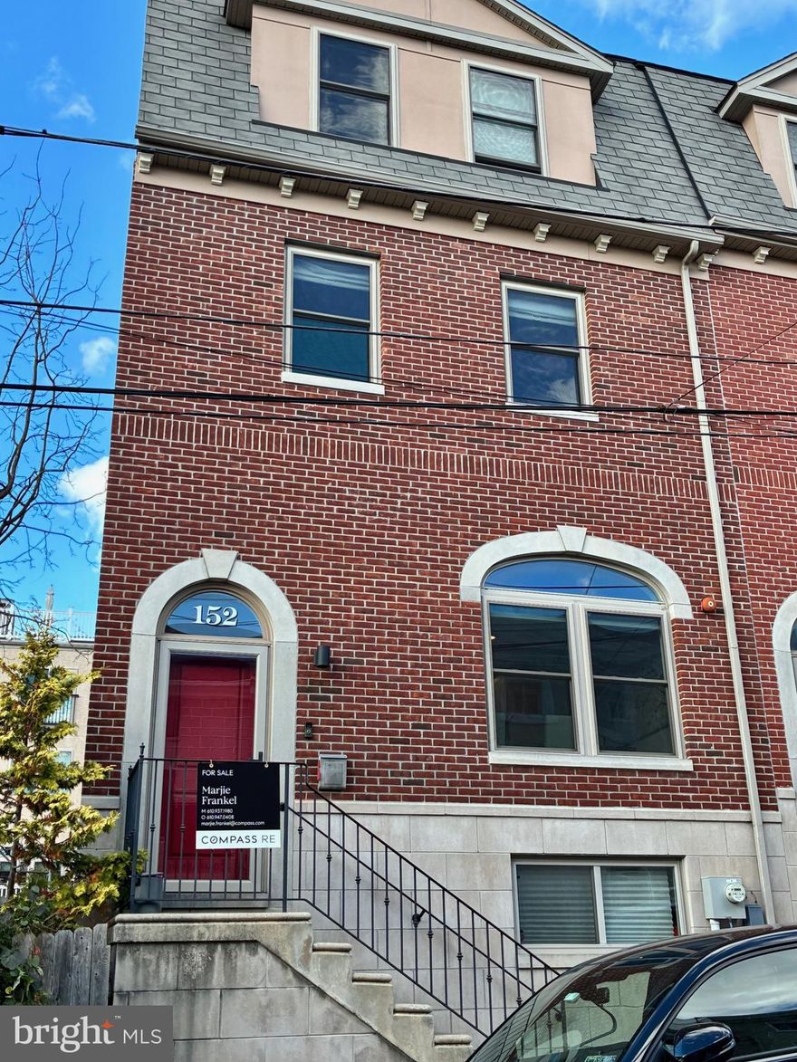 Wouldn't you love the convenience of being able to walk to Manayunk while also having the ease of parking? This  fantastic 3-4 bedroom, 2.5-bath  contemporary brick/limestone end unit townhome is your answer!   Your own private attached  2-car garage, big enough for two SUVs plus two additional off-street parking spaces, gives you the best of both worlds.  Step inside to an open floor plan with a beautiful kitchen featuring quartz countertops, a marble tile backsplash and center island with seating, 42-inch soft-close white cabinetry, stainless steel appliances, pantry, and coffee/wine bar with built in wine fridge and wet bar.  The kitchen opens to a dining area as well as a bright living room leading to private deck.  Moving upstairs to the second level, you’ll find two spacious bedrooms with double closets, a hall bath with double vanity, quartz countertops, ceramic tile flooring, and a tub/shower combo. There’s also a full-size laundry room and plenty of storage space. The third floor private retreat with a double-door entry to the main suite featuring a large bedroom, Juliet balcony, two custom outfitted walk-in closets, and a spa-like bathroom with a glass and marble-tiled walk-in shower, double quartz vanity, and linen cabinet. A smaller fourth bedroom on this level makes for a perfect home office, yoga or hobby room.  Head up to the full roof deck for 360° views of the city — the ultimate spot for entertaining.  The finished lower level adds even more living space and connects directly to the 2-car attached garage. Beautiful hickory floors through out! Perfect Manayunk location, just a couple of blocks to Main Street where shops and restaurants abound. For biking and hiking enthusiasts, Wissahickon trails are minutes away.  Public transportation nearby and easy access to Center City, Philadelphia.  One-2 years left on tax abatement.   2025 taxes are $2040. (may be incorrect on 3rd party site). This home is not to be missed!