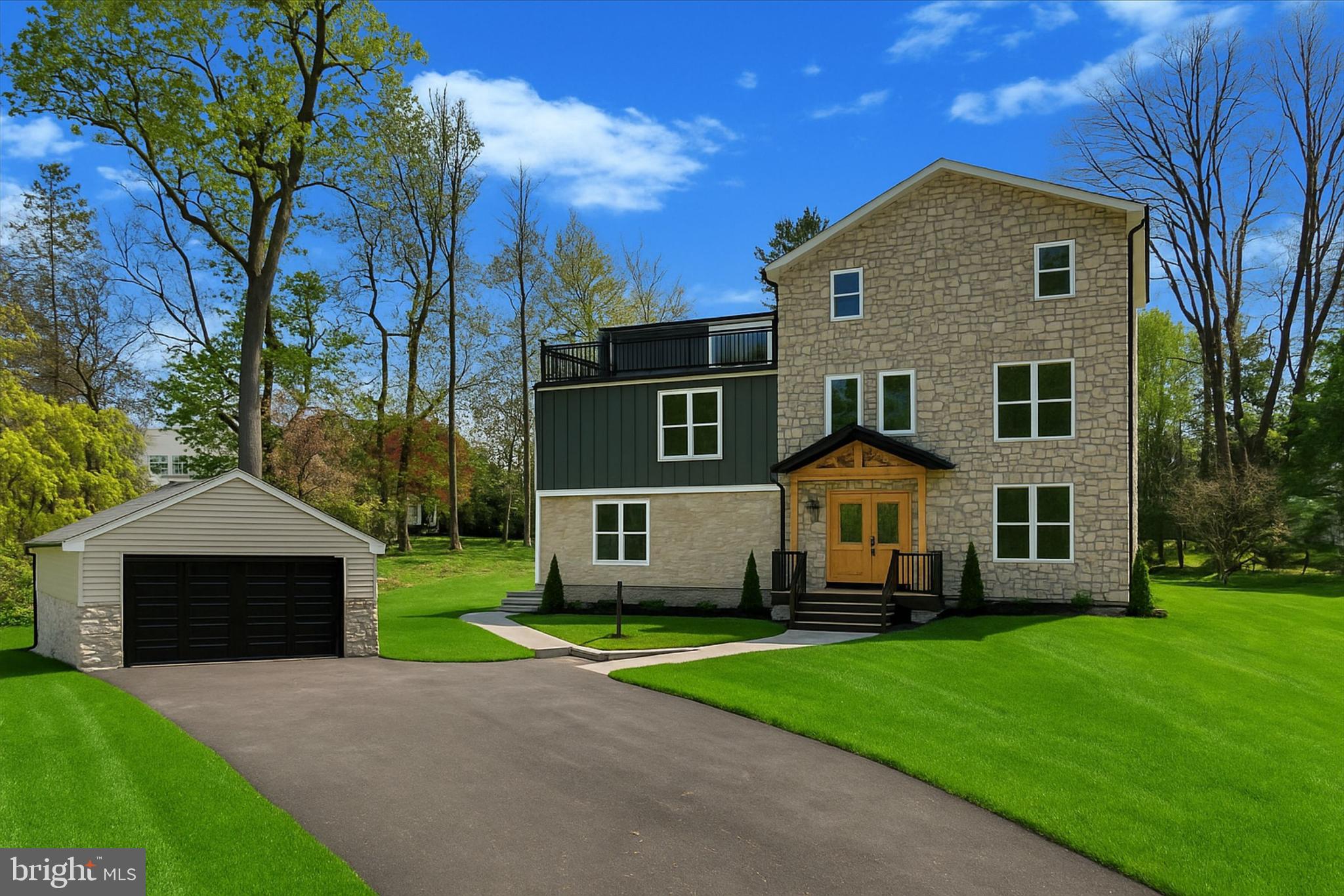 Sitting on nearly an acre, this new construction custom home blends modern luxury with timeless charm in the highly sought-after Lower Merion School District. The seller is offering an $8000 landscaping and landscaping lighting package, as well as a $8000 budget for appliances. Thoughtfully designed with top-tier materials and craftsmanship, this home offers both durability and elegance. Built for lasting quality, the home features Hardie siding and natural stone on the front, with CertainTeed vinyl siding on the sides and back. Viwinco double-hung windows enhance energy efficiency, while the new roof and gutter system includes a seepage bed for proper rainwater management. The home is equipped with a three-zoned forced-air HVAC system. Additional features include a gas tankless water heater for continuous hot water, brand new plumbing, and a brand new 200-amp electrical service. Step onto the welcoming front porch and into the foyer, where you'll immediately notice the stunning craftsmanship and natural light that fills the space. To the right, a formal dining room or flex space offers the perfect setting for memorable dinners or extra living space. Moving past the foyer, the spacious living room provides an inviting atmosphere for relaxation and boasts a gas fireplace. At the rear of the home, the chef’s kitchen features Fabuwood solid wood cabinets with dovetail drawers and soft-close doors, natural quartzite countertops, and a custom range hood. The kitchen also offers a 15 foot long and 9 foot high nano door system that opens all the way up into the back patio. A butlers pantry, and a powder room with custom tile work complete the main level. Upstairs, the primary bedroom is a true retreat, featuring his-and-hers walk-in closets, a luxurious ensuite bathroom with a dual vanity, soaking tub, and massive shower, and a balcony that overlooks the backyard. A second bedroom includes an ensuite full bathroom as well, while two additional equally spacious bedrooms share a third full hallway bathroom. All bathrooms are finished with custom designer tile, Kohler toilets, and Delta faucets. A walk-in laundry room with hook-ups provides added convenience. The third level boasts a substantial den or secondary living room area. Another bedroom, that could also be used as a home office or den, has its' own ensuite bathroom as well. This level also offers a large walk-out balcony, providing additional outdoor space and stunning views. The home is designed for both beauty and function, featuring two walk-out balconies with black metal railings and composite decking, which require no upkeep. The large backyard is a blank canvas, ready to be transformed into a private outdoor oasis. The basement houses all mechanicals, includes a French drain and two sump pumps, and features an epoxy-coated floor for easy cleaning. Additional highlights include: shaker-style custom doors and trim supplied by Freedom Millwork; LED recessed lighting and designer fixtures throughout; decora switches and outlets, plus under-cabinet lighting in the kitchen; a walk-in butler’s pantry with custom cabinetry, shelving, a prep sink, and butcher block countertops; and Sonos wireless speaker system for indoor and outdoor entertainment. Located in the heart of the Main Line, this home is just minutes from Villanova University, the newly constructed Black Rock Middle School, and the charming towns of Bryn Mawr, Wayne, West Conshohocken, and King of Prussia. With easy access to Route 76, 476, Center City Philadelphia, and the airport, this location offers convenience without compromising on space or privacy. This remarkable home is built for modern living, offering timeless design, premium finishes, and unparalleled comfort!