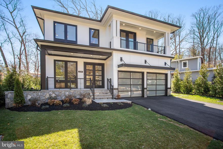 Discover this nearly 6,000 sq. ft. gem in Falls Church, Virginia, just minutes from the Beltway and Tyson's Corner. Upon entry through a grand, double-height foyer, you are immediately captivated by the elegant design of this home. To the left, an executive office features sleek, full glass walls and doors, offering both privacy and light. To the right, you'll find a powder room, coat closet, boot bench, and access to the oversized garage with epoxy floors and modern translucent doors.
Proceed down the hall on the white oak floors that run throughout the house to the family room with a beautifully tiled gas fireplace on the left, and a chef's kitchen adorned with stunning quartz countertops on the right. The kitchen in this Falls Church home is a chef's dream, equipped with high-end GE Cafe appliances and an upgraded Wolf range. The six-burner Wolf range, complete with a griddle, offers unparalleled cooking versatility for various gatherings. The kitchen features a sleek and spacious built-in refrigerator/freezer for ample storage. The super quiet dishwasher ensures a peaceful environment during post-meal cleanup.  A convenient wall oven is perfect for roasting and baking, with a microwave above for quick meal prep. Integrated appliances maintain a seamless kitchen flow, complemented by striking quartz countertops for elegance and durability. Abundant custom Pennsylvania Amish cabinetry provides organization, making it the ultimate space for culinary creativity and casual dining. Experience seamless indoor-outdoor living through a 15-foot sliding door that opens to a covered porch with privacy wall and electronic screens, along with an attached deck. The deck is outfitted with a complete outdoor kitchen, perfect for al fresco cooking and dining.

The main floor also includes a breakfast area and a delightful morning room. Upstairs, discover three spacious bedrooms and a convenient laundry room with ample cabinetry. The primary bedroom offers a cozy sitting area with a fireplace, a private covered balcony with screens, and a luxurious spa-like bathroom featuring a French-styled bath, heated floors, two toilets, dual vanities, and two walk-in closets—one with an island. Additionally, there’s another bedroom with a balcony and en suite bathroom, along with a generously sized princess suite, also with its own en suite bathroom.

On the top level, find a loft office with a wet bar, an additional bedroom, and a full hall bath. The lower level boasts a spacious gallery with ample storage and an entertainer’s dream finished lower level, featuring a beautiful wet bar with refrigerator, dishwasher, ice maker, plenty of cabinetry, and a cozy fireplace with complementing wall niches.

The lower living level also features double doors leading to the exterior and a flexible room ideal for storage. A suite, currently staged as a spa and gym, can easily be converted into another bedroom. This magnificent home combines elegance, functionality, and modern convenience.

Outside in your privacy fence enclosed garden, enjoy a lush, locally sourced improved tall fescue lawn—the ideal turfgrass for Northern Virginia—along with expertly designed landscaping that provides privacy, featuring green giant arborvitaes curated by a professional designer. The carefully selected plants are built to thrive for decades, all complemented by a state-of-the-art in-ground irrigation system.
