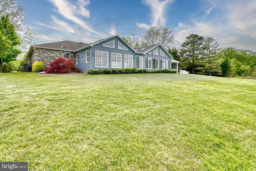 MAJOR PRICE IMPROVEMENT.  THIS PROPERTY IS TRULY ONE OF A KIND.  A TRUE OASIS FOR THE SERIOUS BOATER OR FISHERMAN.  CUSTOM STONE RANCHER ON OVER 2 ACRES WITH 200' OF WATERFRONT, SANDY BEACH, 200' PIER WITH WATER, ELECTRIC AND FOUR BOAT  LIFTS.  GATES OPEN UP TO A CIRCULAR DRIVEWAY.  ENTER INTO THE FOYER TO THE FORMAL LIVING AREA. DINING AND GOURMET KITCHEN, GRANITE COUNTERS AND STAINLESS STEEL  APPLIANCES.    MAIN LEVEL CONSISTS OF THREE BEDROOMS EACH WITH THEIR OWN BATH. ALL BEDROOMS HAVE RECESSED AREA FOR TV, AS WELL AS LIVING ROOM.. STUNNING VIEWS FROM THE KITCHEN, LIVING ROOM AND FAMILY ROOM.  HIGH CEILLINGS, OPEN CONCEPT THROUGHOUT.  BRIGHT AND AIRY. THE EXPANSIVE FAMILY ROOM CONSISTS OF A BAR, TV, CEILING FANS AND AMPLE ROOM FOR GATHERINGS ALL OVERLOOKING A MAGNIFICENT VIEW OF THE WATER.  FIRST FLOOR HAS OVER 3400 SQUARE FEET FINISHED.  LOWER LEVEL IS EQUIPPED WITH A FULL IN-LAW SUITE, INCLUDING BEDROOM, EATING AREA, KITCHEN, NEW BATH, FAMILY ROOM AND OUTSIDE ENTRANCE.  CAR ENTHUSIASTS CAN ENJOY THE FOUR CAR GARAGE IN ADDITION TO THE EIGHT CAR DETACHED GARAGE WITH PARTIAL HEATING.  PERMITS HAVE BEEN GRANTED TO EXTEND DOCK AN ADDITIONAL 150 FEET..NO FLOOD INSURANCE REQUIRED SINCE PROPERTY SITS 20' ABOVE HIGH TIDE.  PARADISE AT ITS FINEST.  MUST SEE TO APPRECIATE THE QUALITY AND WORKMASHIP IN ALL AREAS OF THIS HOME.