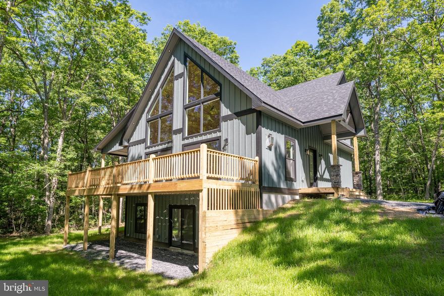 NEW CONSTRUCTION – Modern Mountain Craftsman at Deep Creek Lake – Finished in spring of 2024, This brand-new 5 bdrm, 4.5 bath chalet style craftsman is situated on over an acre of wooded land, and features 3050 sq ft of pristine living space, bright and contemporary finishes, open concept living and vaulted tongue & groove ceilings that make way for a wall of glass to let in the light! Main level primary with walk-in closet, tiled shower and double bowl vanity. Luxurious modern kitchen with stainless appliances, quartz tops and island bar seating. Stacked stone fireplace in the main living area. 2nd living space or rec room on the lower level. Sprawling deck with covered outdoor fireplace. Just minutes from local restaurants, marinas, state parks and Wisp Resort – this sleek and modern mountain home offers the perfect blend of convenience and privacy… Call today for details!