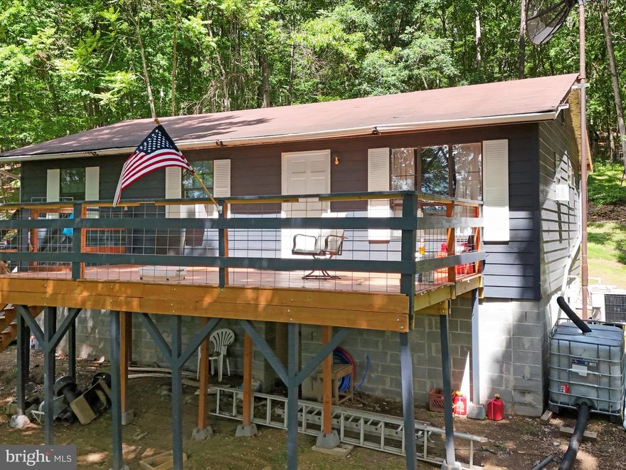 Discover the simple joys of cabin living in Hampshire County, WV. Tucked away on a peaceful 5.00-acre wooded lot, this quaint cabin offers a quiet retreat from the busyness of everyday life. Featuring 3 bedrooms, 1 full bathroom, and 912 sq. ft. of cozy living space, it's the perfect spot to unwind and recharge. Step inside and you'll find a comfortable interior with everything you need. The kitchen is equipped with basic amenities, designed with efficiency in mind, while the bedrooms provide a peaceful place to rest after a day of exploring the great outdoors. Outside, the wooded surroundings offer plenty of privacy and space to roam. Take a leisurely stroll through the trees or simply relax on the deck and listen to the sounds of nature. Located near the Short Mountain Wildlife Management Area, outdoor adventures are just a short drive away. With over 8,000 acres of public hunting and hiking opportunities, there's always something new to discover. Whether you're looking for a weekend getaway or a permanent retreat, this cabin is an attractive option that won't break the bank. Schedule a showing today and experience the tranquility of cabin life in Hampshire County. Property being conveyed strictly "As Is".