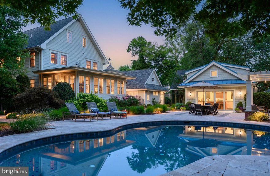 Welcome to "The Mill," an iconic residence in the heart of downtown Lewes that seamlessly blends historic charm with modern luxury, situated on almost a half-acre. Dating back to 1860 as the Jones Brothers Flour and Grist Mill, this distinctive property later served as a brush factory in the 1920’s before being converted into multiple apartments. In 1998, The Mill was taken down to the studs and transformed into a stunning single-family residence. The current owners, who purchased the property in 2012, have since made numerous updates, including the priceless addition of a custom-designed outdoor kitchen and exterior entertaining spaces. Upon entry, you're greeted by soaring ceilings and wide plank hardwood floors that exude warmth, class and character. The spacious family room is a true centerpiece, featuring original post and beam accents, built-ins, and a cozy gas fireplace. This inviting space flows effortlessly into the gourmet kitchen, truly, a chef's dream. The kitchen is outfitted with commercial grade stainless steel appliances including dual ovens, 6-buyer Wolf cooktop, Sub-Zero refrigerator, and beverage fridge. The sleek quartz countertops, farmhouse sink, large prep island, abundant cabinetry, wet bar with wine fridge, and a walk-in pantry create the most attractive and functional spaces. Neighboring the kitchen, you will find the formal dining room adorned with intricate dental moldings, wainscoting, a gas fireplace, and a chandelier that adds a touch of sophistication. For more intimate gatherings, the cozy den or game room offers a welcoming atmosphere with detailed moldings, a gas fireplace, and French doors. The sunroom bathes in natural light with brick flooring, white paneled walls and ceilings, exposed beams, and expansive windows that overlook the pristine pool and manicured yard. Ascend the staircase or take the elevator to the second level, where the luxurious primary suite awaits. The classic wide plank hardwood floors continue, a gas fireplace offers a warming ambiance, exposed beams highlight the historic charm, and a custom walk-in closet offers complete functionality. The ensuite bath offers a spa-like retreat with dual sinks, a soaking tub, and a tiled walk-in shower. Two additional guest bedrooms and a laundry closet complete this level. The third level, accessible by stairs and elevator, is a versatile space with vaulted ceilings, exposed beams, built-in cabinetry, and skylights. This level includes a rec room, kitchenette, two additional guest bedrooms, and a full bath, making it the ideal guest quarters! The garage wing was designed for convenience and versatility.  A spacious laundry room featuring ample storage, counter space for folding, a utility sink, towel hooks and an additional fridge/freezer can be accessed from the driveway or rear yard.  This is the ideal drop zone following long days on the beach, boating or relaxing by the pool.  This space also includes a full bath with outdoor access, perfect for pool parties and outdoor entertaining!  This multi-purpose laundry opens to a foyer that leads to the spacious 2-car garage.  From this location you can also access an additional half bath, and a second-level flex space above the garage that is currently used as a home gym. This area could easily be transformed into a home office, movie room, craft room, or playroom.  Step outside to your private retreat, where meticulously landscaped grounds surround a refreshing in-ground pool. Spend cool evenings by the fire under the cozy pergola or whip up delicious meals in the outdoor kitchen, complete with large grill, refrigerators, dishwasher and a commercial-grade pizza oven. These outdoor spaces are perfect for creating lasting memories under the sun or stars. With the convenience of off-street parking and a location  steps away from everything downtown Lewes has to offer, "The Mill” is truly a unique and unparalleled residence.