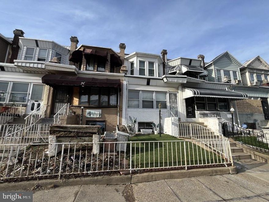 Charming two-story brick rowhome built in 1925, located in the Kingsessing section of Philadelphia. This home features an enclosed front porch, a spacious living room and dining area, and a kitchen with walkout access to a fenced rear yard. The upper level offers three bedrooms and one full bathroom. Additional highlights include an unfinished basement, ample on-street parking, and a small front yard. Conveniently situated near local shopping, public transportation, and just minutes from major roadways, this property offers both character and accessibility.