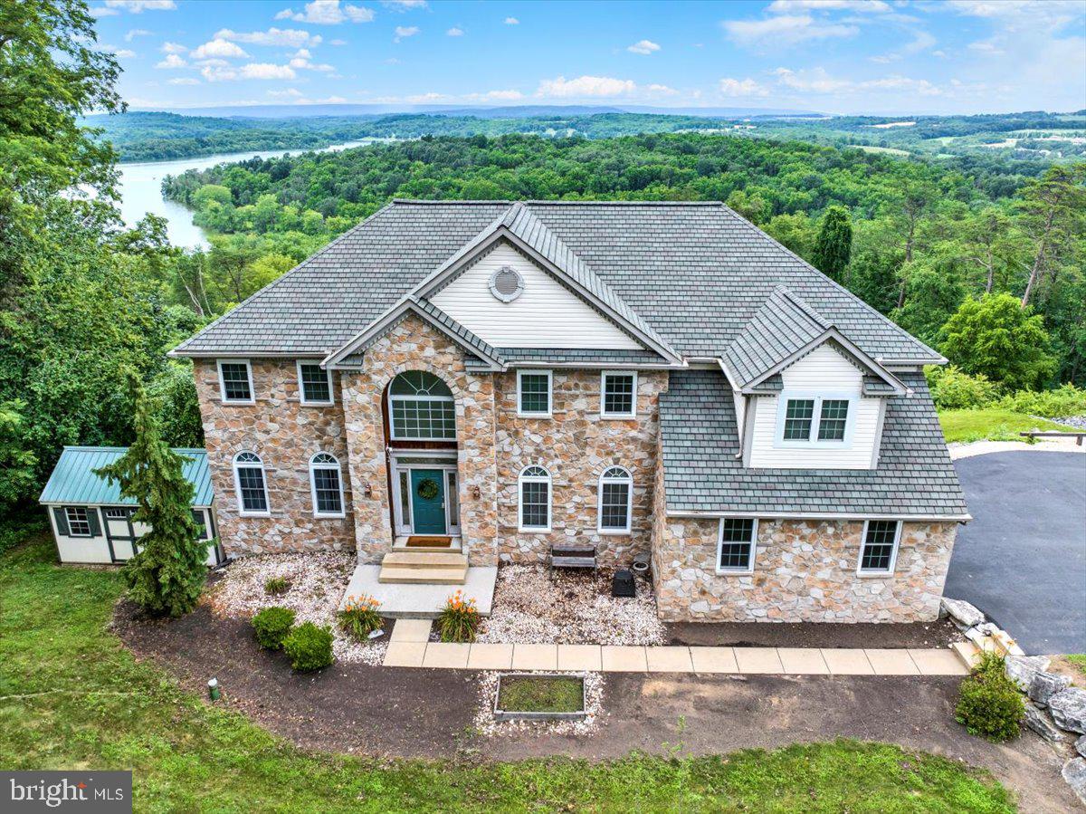 PRICE IMPROVEMENT! Welcome to 465 Rebers Bridge Road! This gorgeous home could be your everyday getaway. Located in the heart of Wilson School District, where stunning views of Blue Marsh Lake and the Berks County countryside greet you from nearly every window. This modern 4-bedroom home offers an open, light-filled layout designed to maximize both comfort and the incredible natural scenery. A spacious kitchen and formal dining room make hosting easy, while large windows throughout the home bring the outside. Enjoy first floor laundry as well on this level. Downstairs, a generous finished area with a built-in bar and kitchen offers the perfect space for game nights, gatherings, or quiet evenings enjoying the view. Upstairs, you’ll find four comfortable bedrooms, a full bath, including a primary suite complete with a walk-in closet, additional laundry, and its own private bath. Don’t miss the chance to live in one of Berks County’s most picturesque settings. This spacious home is truly a retreat. Open House, July 10th from 5:00-7:00 p.m.