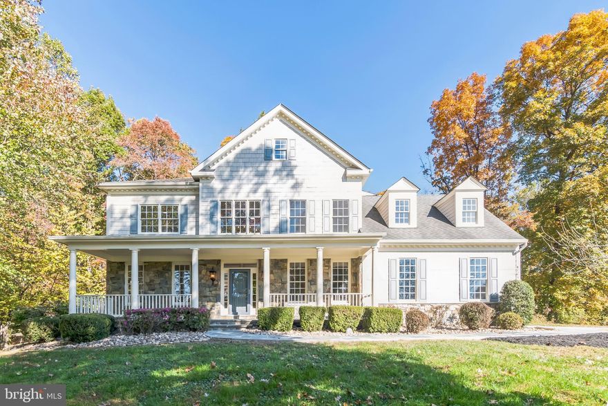 This stunning 6-bedroom, 5-bathroom detached Colonial seamlessly blends elegant design with modern functionality.  The grand foyer greets you with soaring two-story ceilings, creating a bright and airy entrance that sets the stage for elegance throughout the home. Rich hardwood floors extend across the main living spaces, while intricate crown molding and wainscoting lend sophistication to the formal areas. The open-concept design allows for a seamless flow from the foyer to the living and dining rooms, making it perfect for hosting gatherings and everyday comfort. Anchoring the family room is a stunning natural stone fireplace. The main floor is thoughtfully designed with a spacious bedroom and a full bathroom, ideal for guests or multi-generational living. In addition to the formal dining room, this level also includes a private office and a large, updated kitchen. The gourmet kitchen caters to culinary enthusiasts with a center island cooktop, double wall ovens, and sleek stainless-steel appliances. Expansive windows throughout the home flood the interior with natural light and offer tranquil views of the beautifully landscaped surroundings. Upstairs, you’ll find five additional bedrooms and three full bathrooms, including a luxurious primary suite. The primary bedroom boasts a spacious walk-in closet with custom built-ins, along with a spa-like bathroom featuring dual vanities, a soaking tub, and a walk-in shower. Two sets of bedrooms share convenient Jack-and-Jill bathrooms, providing privacy and functionality. The finished basement includes a full bathroom, additional storage space, and the potential for a game room, home gym, or media room. The exterior of the home is perfect for entertaining, with a sprawling flagstone patio that features a built-in grill and fire pit, offering a seamless flow between indoor and outdoor living. The attached two-car garage not only offers ample storage but also includes a Tesla charging station for added convenience. A gas furnace ensures cozy winters, while the electric hot water heater provides energy-efficient comfort year-round.  This home seamlessly combines elegant design with functional space. With a versatile floor plan, stunning outdoor spaces, and modern amenities, this property is ideal for comfortable living, hosting gatherings, and creating unforgettable moments.