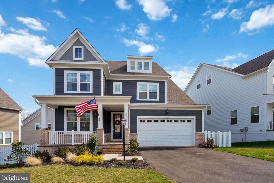 Welcome to 18150 Marsh Pine Rd in the highly sought-after Potomac Shores, where modern design, thoughtful upgrades, and an unmatched lifestyle come together. This beautifully maintained one-owner home features a rare dual primary suite layout with spacious bedrooms on both the main and upper levels, offering ideal flexibility for multigenerational living or long-term guests. The heart of the home is a stunning open-concept kitchen and living space, complete with a large center island, upgraded cabinetry, stainless steel appliances, and seamless flow into the main living area—perfect for everyday living and entertaining. Natural light fills the home, highlighting the dedicated office, wide open floor plan, and clean, modern finishes throughout. Step outside to a private outdoor retreat featuring a spacious deck and an expansive stamped concrete patio below, all overlooking a fenced backyard that backs to woods—creating a peaceful and private setting rarely found in the community. The fully finished lower level offers incredible versatility with a large rec space, media area, and additional storage, making it ideal for entertaining, working, or relaxing. Additional upgrades include a Tesla charger, smart appliances, in-home speaker system, surround sound wiring, irrigation system, and multi-zone HVAC for maximum comfort and efficiency. Situated on a quiet street with one of the better lot positions in the neighborhood, this home also includes HOA-covered Verizon internet and access to Potomac Shores’ incredible amenities, with the future VRE station and town center on the way, making this a prime opportunity in one of Northern Virginia’s fastest-growing communities.