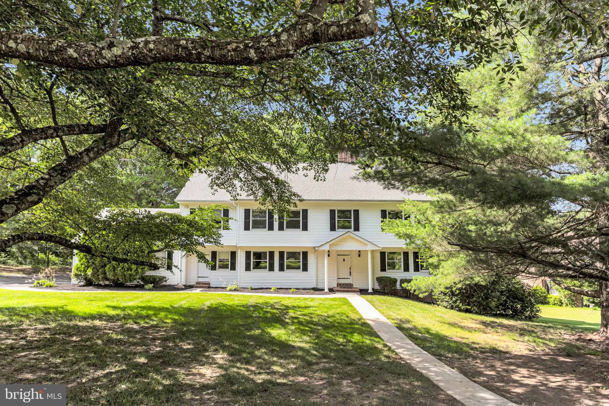 Step into timeless elegance with this exquisite Colonial residence, peacefully set amidst serene woodland surroundings. A sweeping foyer welcomes you into the heart of the home, where a spacious living room—with a warm, wood-burning fireplace—beckons gatherings and intimate conversations alike.
Just steps away, the family room offers a second cozy retreat by its charming brick fireplace and flows effortlessly into an expanded kitchen and generous breakfast area, thoughtfully paired with a bright, versatile office space. The kitchen is truly the centerpiece of family life, featuring a grand island that serves as the perfect stage for meal prep, casual dining, and connection.
Hosts and guests will appreciate the formal dining room—a refined space made for special occasions and holiday feasts. A well-appointed laundry room on the main floor enhances everyday convenience.
Upstairs, you’ll discover four beautifully proportioned bedrooms, including a luxurious primary suite designed for relaxation. The primary bath offers a spa-like retreat, complete with premium fixtures and plenty of space to unwind.
Descend to the lower level to uncover even more flexibility: a fifth bedroom—ideal for visiting guests or a home office—as well as an inviting entertainment room ready for movie nights, playtime, or socializing.
Outside, experience true tranquility with a screened porch and open deck, both overlooking lush woodland vistas that promise both privacy and natural beauty. This home masterfully balances traditional charm with modern comfort, creating the perfect backdrop for a lifetime of memories.