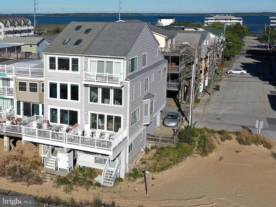 PRICE REDUCTION! AMAZING PANORAMIC DIRECT OCEAN FRONT VIEWS! A UNIQUE TOWNHOME WITH OVER 3,200 SQUARE FEET OF COASTAL LIVING, 5 BEDROOMS, 4 FULL BATHS! NO CONDO FEES! Home is Spacious Enough To Entertain ALL Of Your Family & Friends, With ELEVATOR ACCESS TO EVERY FLOOR! Front Door Entry Has Been Updated To Accommodate A Coat Closet  & Foyer Leading To The 1st Level Of The Townhome Or Into The Garage & The Private Entrance To A Tiled Guest Room W/Full Bath, Private Deck & Beach Access. Use The Elevator Or Stairs To Head To The Main Living Area, Kitchen & Dining Room.  The Breathtaking Direct Ocean Views & Cathedral Ceilings Let In An Abundance Of  Natural Light & The Cool Ocean Breezes! Tiled Floors In The Main Living Area Makes For An Easy Clean Up After A Relaxing Day At The Beach Or Take In The Smell & Sounds Of The Ocean On The Oversized Deck Off Of The Living Room. Guest Room W/Full Bath For Company That Needs To Be Close To The Kitchen! The Third Level Offers A Perfect Home Office In The Loft W/ Expansive Ocean Views; 2 More Spacious Bedrooms & A Full Bath On This Floor As Well! The Entire 4th Floor Is The Private Master Bedroom Suite! An Extra Closet Has Been Added & A Mini Split System Keeping Your Floor At The Perfect Temperature Summer Or Winter! Enjoy Warm Evening Breezes On The Private Back Deck Off The Master Bedroom & Wake Up To The Gorgeous Sunrises Before You Get Out Of Bed In The Morning! Owners Have Made Updates That Include, Newer HVAC Units, Windows, Sliders, Tiled Flooring, Carpet, Outside Decking & Outside Shower. Everything That Makes This Home Stand Out From All The Others! 
Comes Mostly Furnished W/Few Exclusions.  Easy To Show!