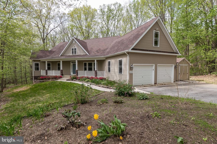 Private wooded 3+ acres custom designed & built 4 bed, 3.5 bath. Gorgeous HW floors throughout. Gourmet kitchen w/ breakfast rm, overlooks great/fam rm w/ gas FP. Rear covered deck and screened porch. First floor master suite w/ office/nursery, & huge closets, BA w/ walk-in shower, soaking tub & dual sinks. Finished walk-out BSMT,w/ fam rm and space for workshop, tons of storage! Hereford Schools!