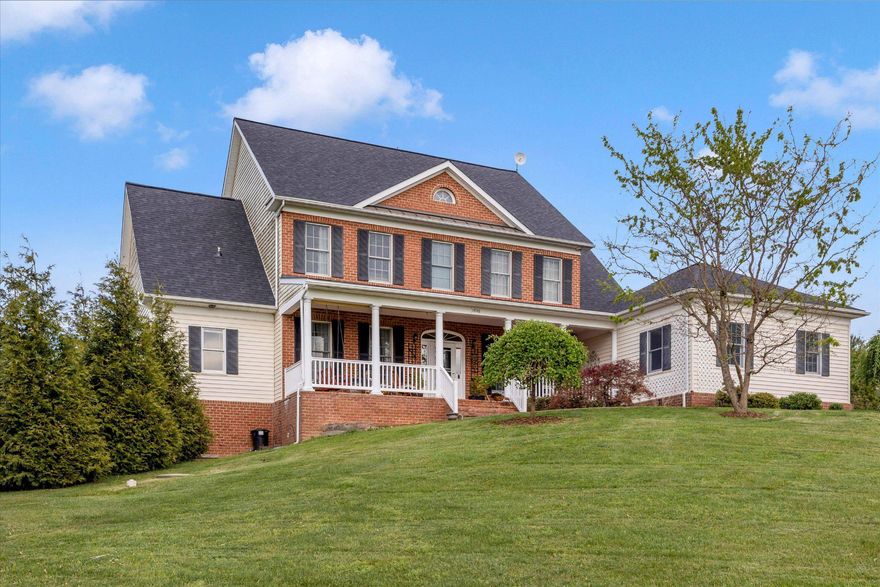 BRAND NEW ROOF with 50 year warranty! This stately brick-fronted Estate-Style 5,700 sf Colonial w/6-bedroom, 4.5 bath sits on a small knoll and features 360 degree views. Inside this smart home, the expansive interiors lend themselves to gracious living in a beautifully landscaped pastoral setting.  Set back off the road, this petite pocket neighborhood (NO HOA) of elegant homes on large lots is surrounded by hundreds of acres of farmland. Perfect for a family that entertains or a multi-generational family, this home features, inside and out, multiple spaces to gather, multiple places for privacy, with plenty of flexible space that can be adapted to suit any set of needs at any given time. 

The interior of the home tastefully combines classical design elements with contemporary touches and blends the best of traditional dedicated rooms with open-space concept areas. 9’ ceilings, crown molding and hardwood floors throughout, tons of window, traditional ceiling medallions. Foyer opens on one side to a library/study/home office, and on the other side to a formal dining room; a gracious contemporary living room with traditional touches, such as the colonial detailing on the fireplace mantel and French doors opening to more outdoor living spaces. 

Open concept Kitchen/Breakfast Room/Sunroom captures abundant east and south natural light. Nicely sized island, granite counters, stainless steel appliances, plus cherry cabinets with BOTH undermount and overmount lighting!  Main level mudroom to the 2-car garage – yes, with the indoor charging station. 
Massive main-level primary suite gets morning light from oversized windows and opens to a deck. Ensuite has jetted soaking tub, separate shower, separate sink vanities and a makeup vanity – and of course an ample-sized walk-in closet. 
Upstairs is a junior suite (bedroom with walk-in closet and a private bathroom), two bedrooms (with walk-ins) joined by Jack-and-Jill bath, and then a large, finished room with smaller interior room that is open to interpretation. Bedroom? Family Room? Home office? Home schooling? Convert to a second master suite? 

Meanwhile, 1,400 sf of lower level was upgraded and updated in 2019. The comfortable lounge/gathering room centers on sleek, contemporary, eco-friendly flush mount electric fireplace, with plenty of room for pool table and more. The high-design expansive bar could have been plucked out of an on-trend boutique hotel! All the right things are present:  wine fridge, second drink fridge, sink, dishwasher and a combination microwave/convection oven. A nook is ready for a kegerator or full-size fridge.  Plus, a full-size bedroom and an upscale European spa-style full bath. French doors open to yet another at-grade outdoor entertaining area. Entire lower level could easily be set-up for au pair or in-laws 
Gardens are extensive and every week something new is blooming or sprouting, so photos cannot do justice to the grounds. Gardens include flowers, vegetables, herbs - not to mention raspberry, blackberry and blueberry shrubs-dream for those who love to can! Gardens are chemical free for last 10 years. Additional outdoor living spaces on all sides of home: Spacious brick front porch promises magical sunsets; Lunch under the wisteria draped pergola; Cocktails while grilling; Built-in fire pit for star gazing, and more!
Smart recessed lighting throughout, remote controlled for brightness and type of light (daylight, reading, etc.). Smart thermostats. Ring Cameras. GloFiber optic has been laid and has been promised to be available soon! Meanwhile, sellers rave about Starlink's service & reliability.  LOCATION: Minutes from numerous wineries, breweries and farm markets. Reasonable commute times to Frederick, Baltimore, Fort Meade, Fort Detrick, the 270-Biotech Corridor, Columbia, Ellicott City and Westminster.