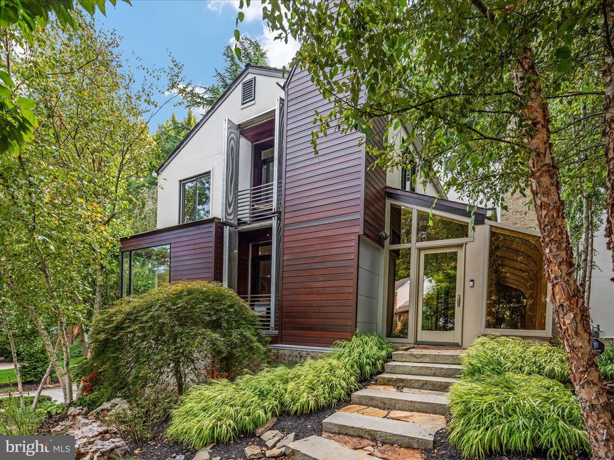 Welcome to 5833 Upton St, an unparalleled masterpiece nestled in one of McLean’s most coveted neighborhoods. This exceptional property offers a serene escape with its prime location backing to protected woods, ensuring ultimate privacy, tranquility, and breathtaking natural views that can never be developed.

From the moment you arrive, you'll be captivated by the extraordinary design of the extensive hardscaping, thoughtfully curated with stone paths, seating areas, and reflective spaces that blend harmoniously into the landscape. A sprinkler and exterior lighting system enhance the outdoor experience, while a massive wrap-around deck effortlessly integrates with the surrounding scenery, offering the perfect space to relax and entertain.

The home’s contemporary architecture with mid-century modern details exudes both style and sophistication. One of its most unique and standout features is the custom ELEVATOR, which conveniently connects the garage to the main and upper levels—offering both functionality and a luxurious touch rarely found in the area.

Inside, the meticulous attention to detail is evident at every turn. The home has been maintained to perfection, and no expense has been spared in ensuring top-quality finishes throughout. The foyer, a stunning sunroom with a rock garden, brilliantly ties the home’s exterior elements to the interior, creating a seamless flow of natural stone and light.

Speaking of light, this home boasts huge windows offering gorgeous panoramic views of the surrounding trees and landscape. The mini recessed lighting throughout the house allows you to showcase art and create an elegant ambiance in every space.

The lower level features a bedroom and full bath, a cozy rec room with a fireplace, and convenient outdoor access. On the main level, you’ll find a gourmet kitchen (with built-in table and remote window treatments) that flows effortlessly into the living room with another fireplace, dining room, and expansive deck. The upper level offers four more spacious bedrooms and two beautifully appointed baths, perfect for family and guests alike. The primary suite includes a built-in queen-sized bed with headboard and base that includes a remote controlled lift for a TV and a built-in dresser.  The primary bath and huge, custom-fitted closet complete the luxury suite.

A home this unique is a rare find. Its blend of natural beauty, contemporary design, and one-of-a-kind features makes it truly stand apart from anything else in the area. Come experience the tranquility, luxury, and unmatched charm of 5833 Upton St—you won’t find another home like this.  Be sure to check out the 3-D Tour.